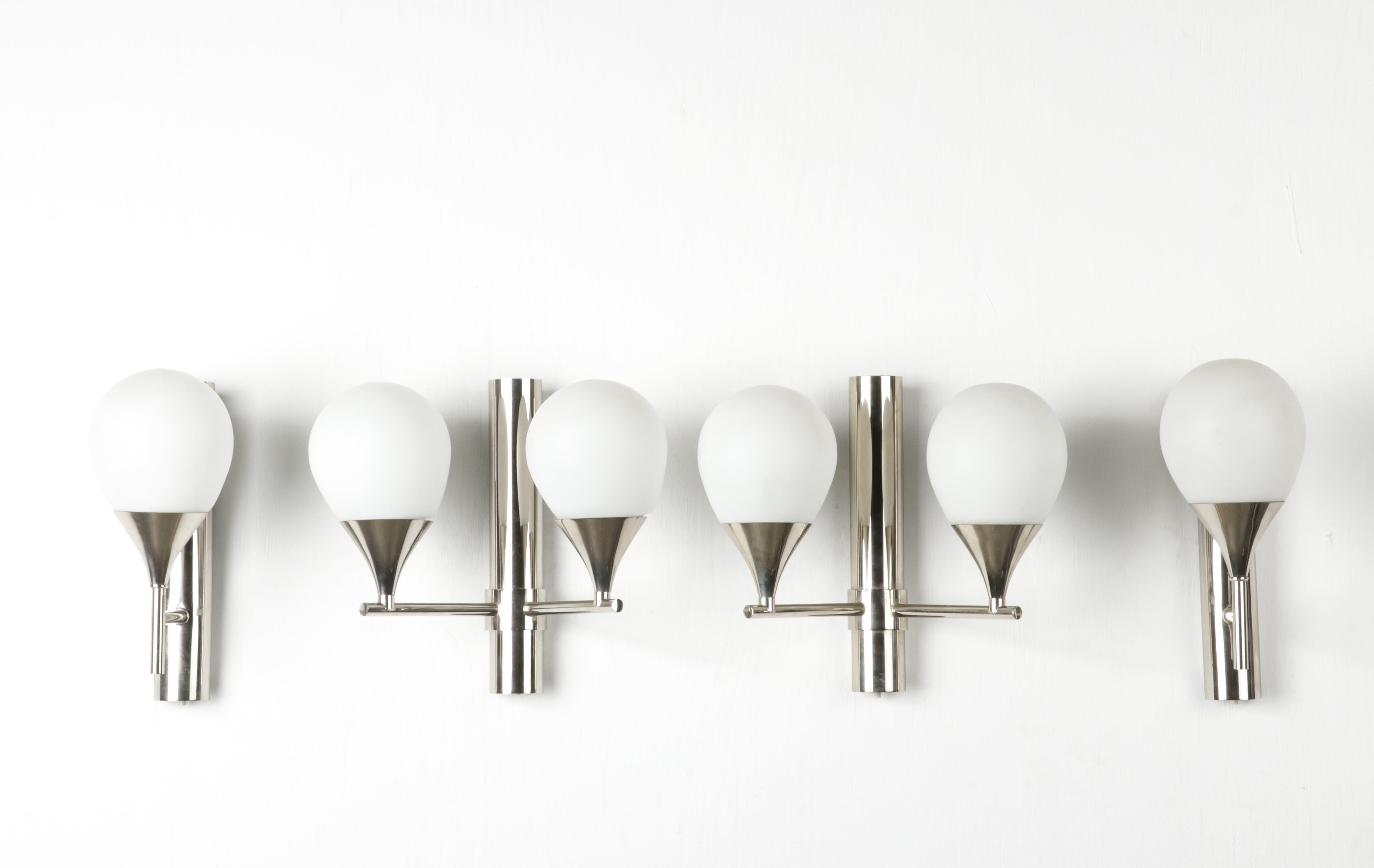 A set of Mid-Century Modern wall lamps, two with a single lamp and two with a double lamp. They were most likely made by the Belgian company S.A. Boulanger, they manufactured also a lot lightings for the Italian designers, such as Scilori. The