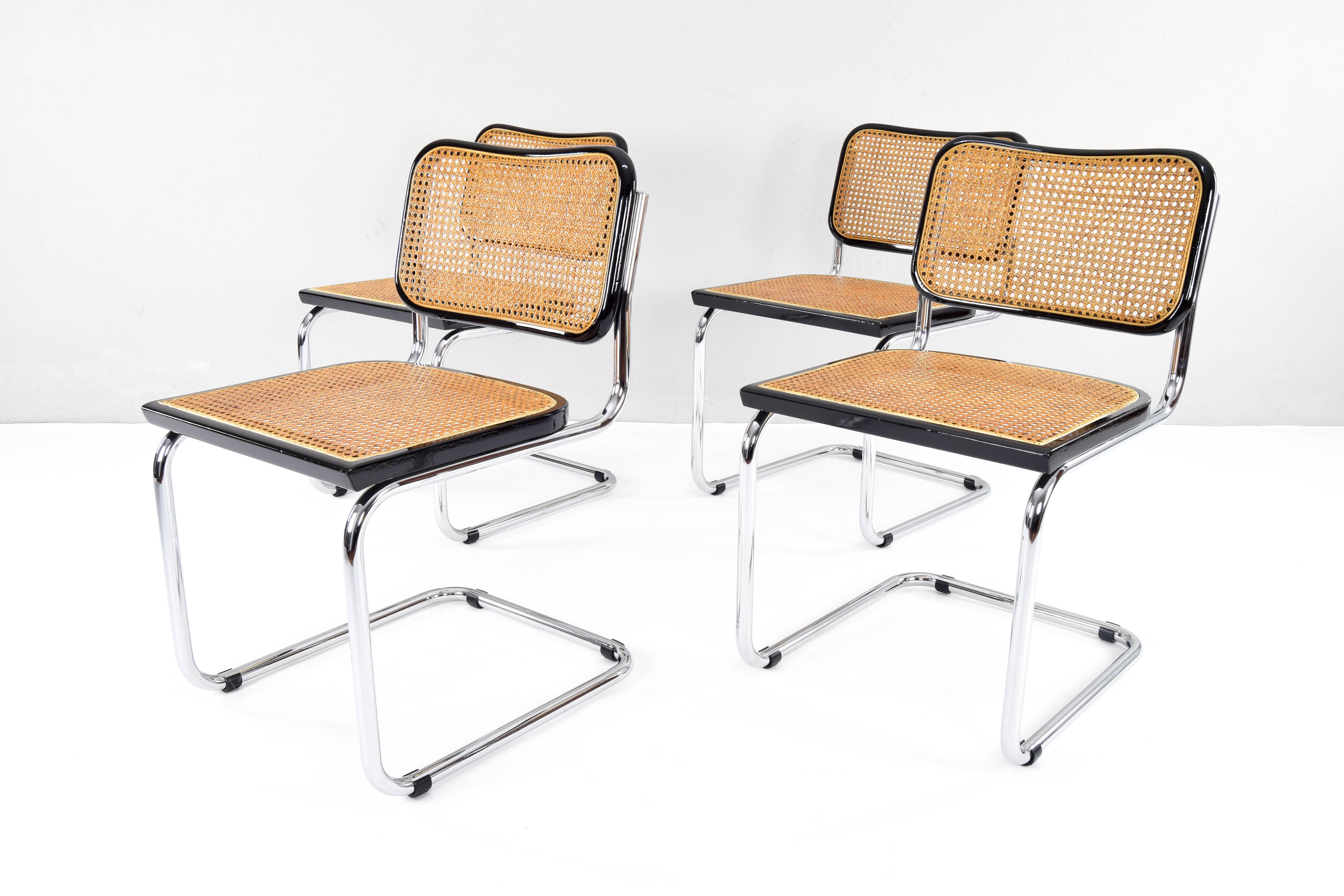 Set of four Cesca chairs, model B32, manufactured by Cidue, Italy in the 1970s. 
Chrome tubular structure in very good condition. Beech wood frames lacquered in black and Viennese natural grid. The natural fiber grilles of the four seats have been
