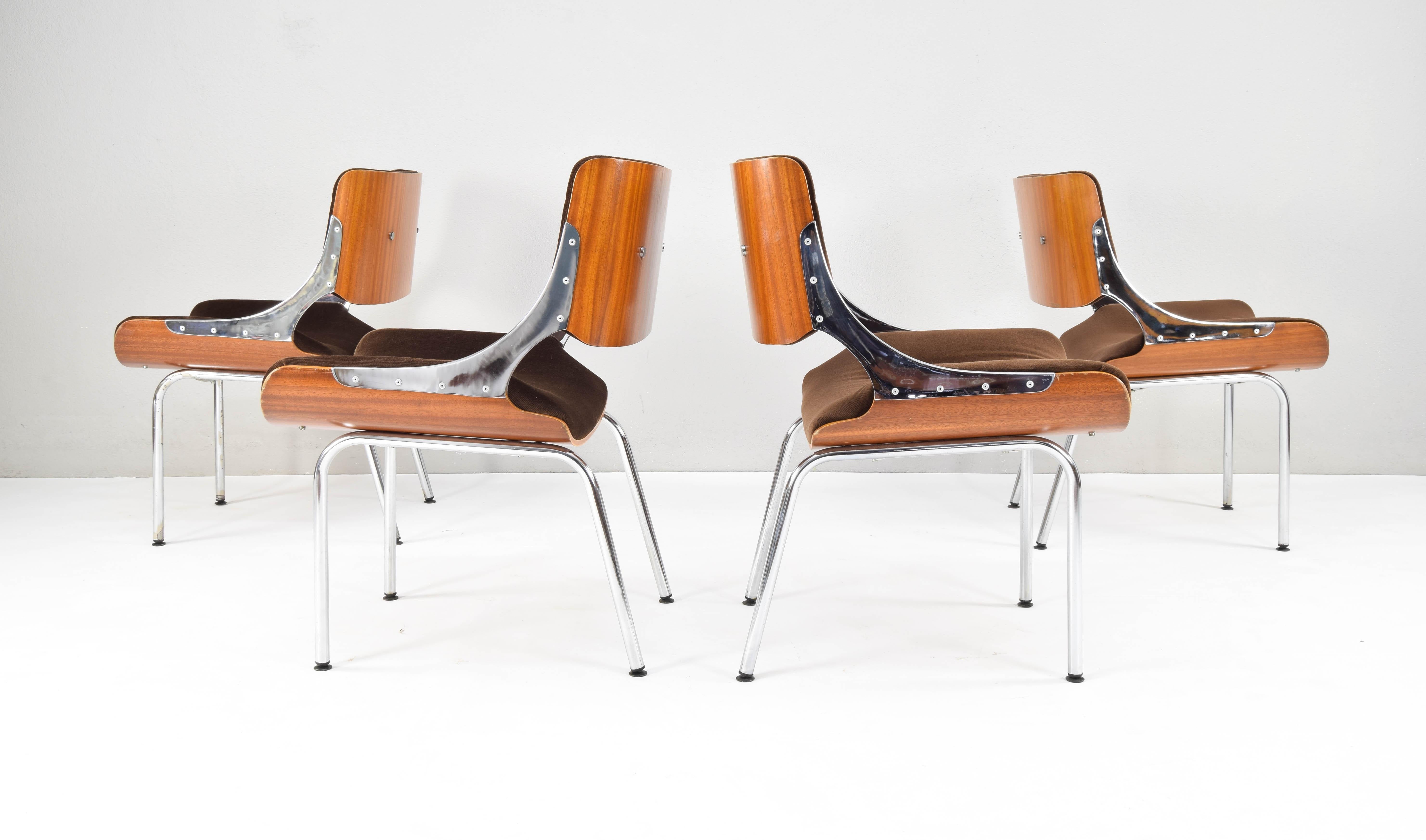 Set of four Danish chairs from the 1960s.
Back and seat in laminated teak wood and upholstered in chocolate brown corduroy. Each backrest is joined to the seat by a piece of chromed steel on each side.
This peculiar combination of materials and