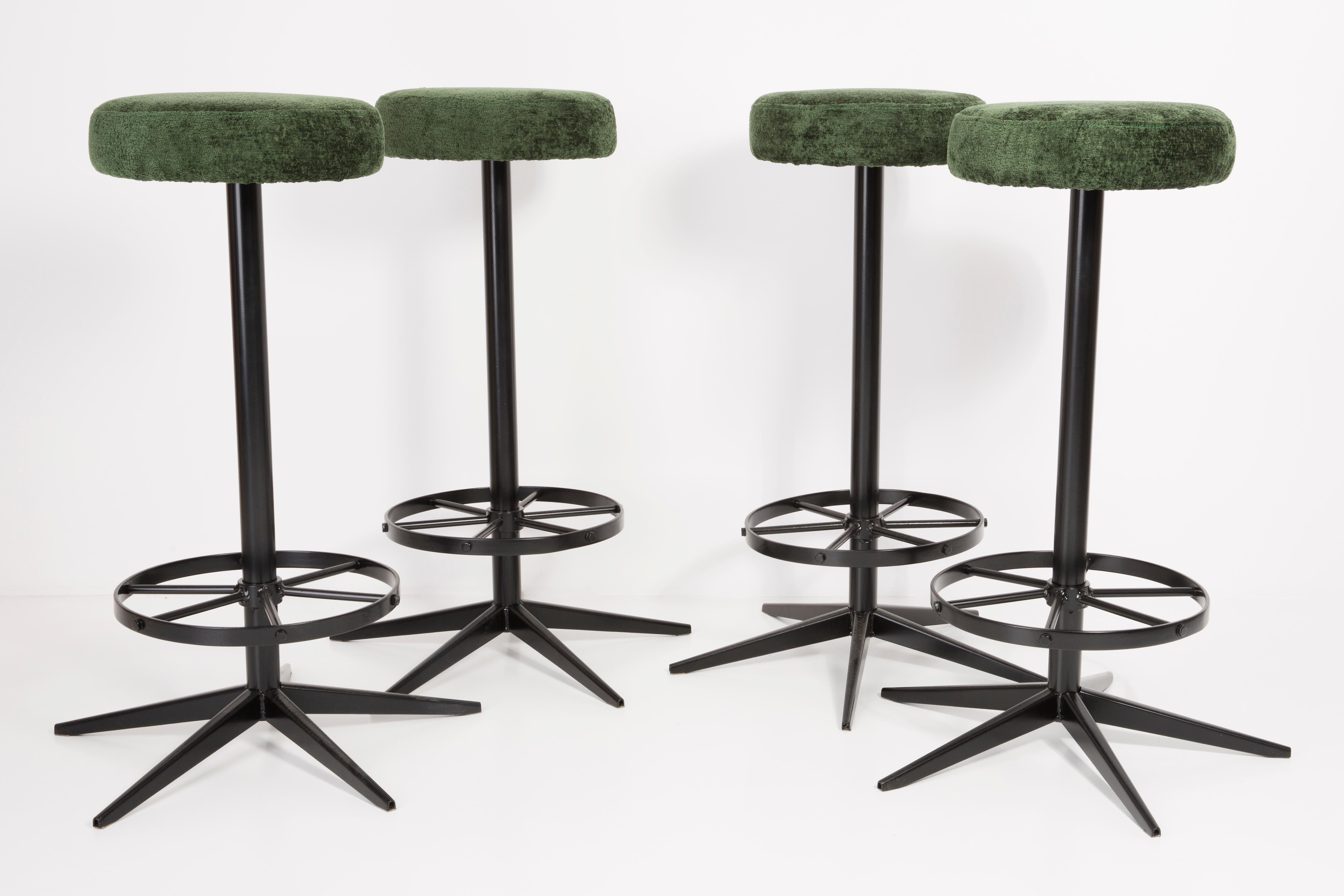 Stools from the turn of the 1960s. Produced in Germany. Beautiful, well crafted dark green italian upholstery. The stools consists of an upholstered part, a seat and steel black legs. They are not regulated. The height is constant.
