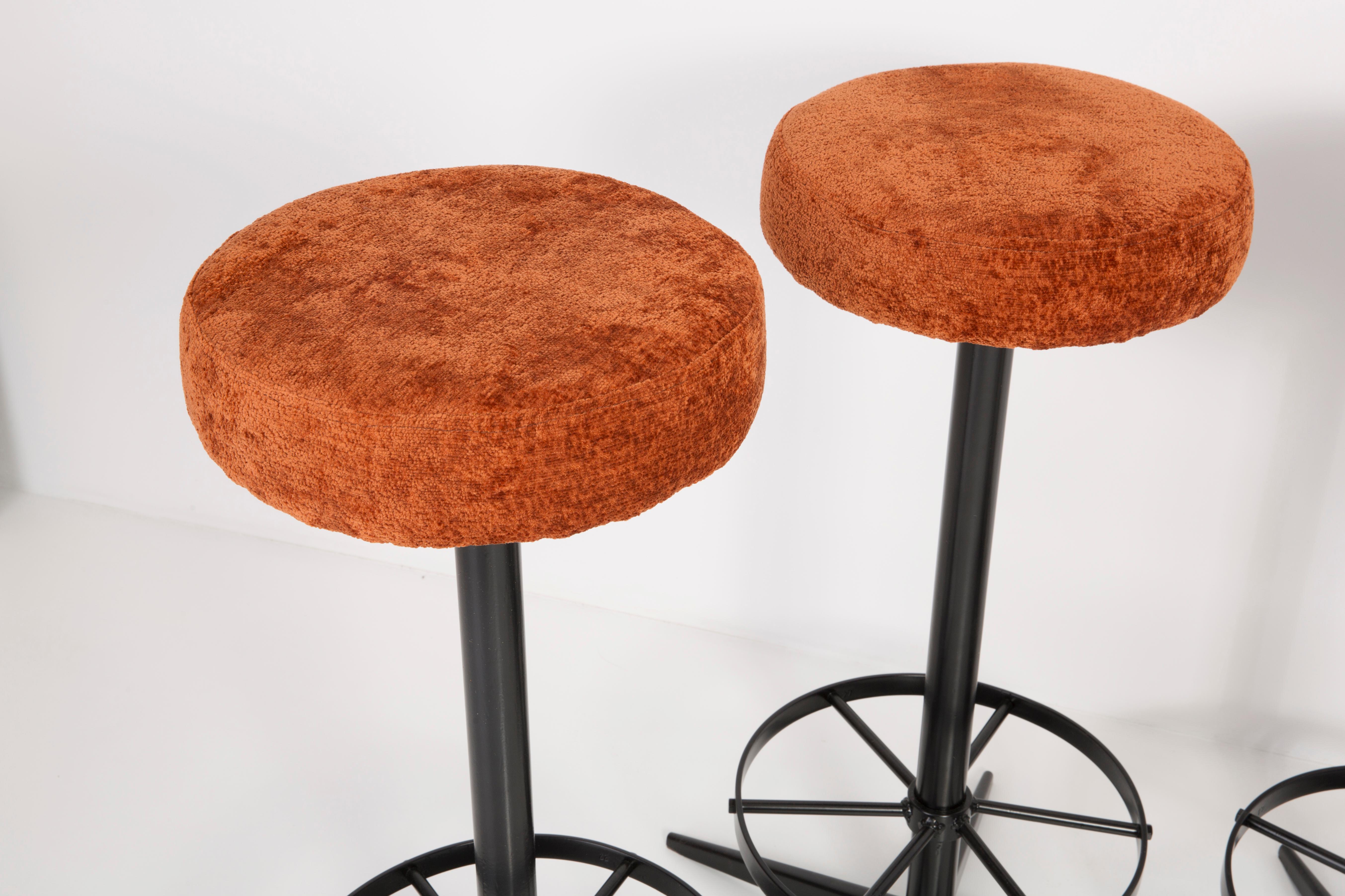 Stools from the turn of the 1960s. Produced in Germany beautiful, well-crafted dark orange upholstery. The stools consist of an upholstered part, a seat and steel black legs. They are not regulated. The height is constant.