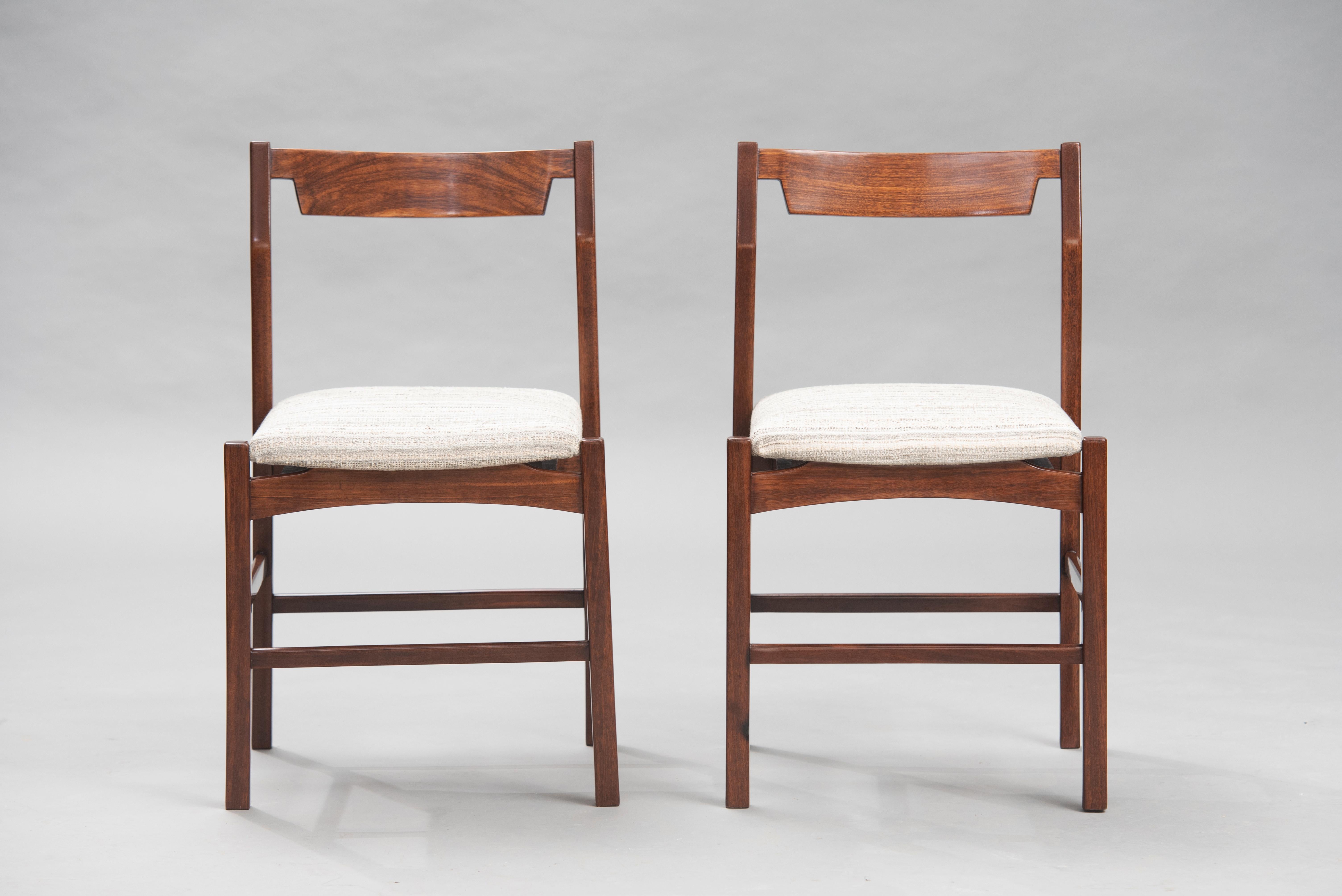 Set of four Mid-Century Modern wenge dining chairs reupholstered in a striped-lined fabric.