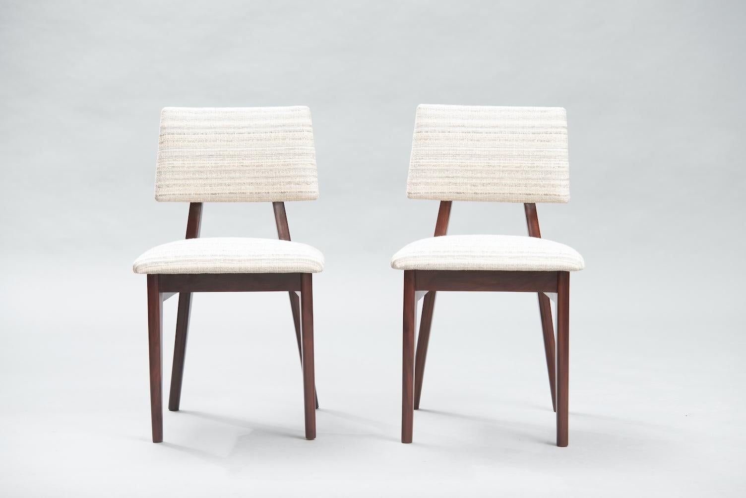 Set of four Mid-Century Modern solid mahogany dining chairs reupholstered in a striped-lined fabric.