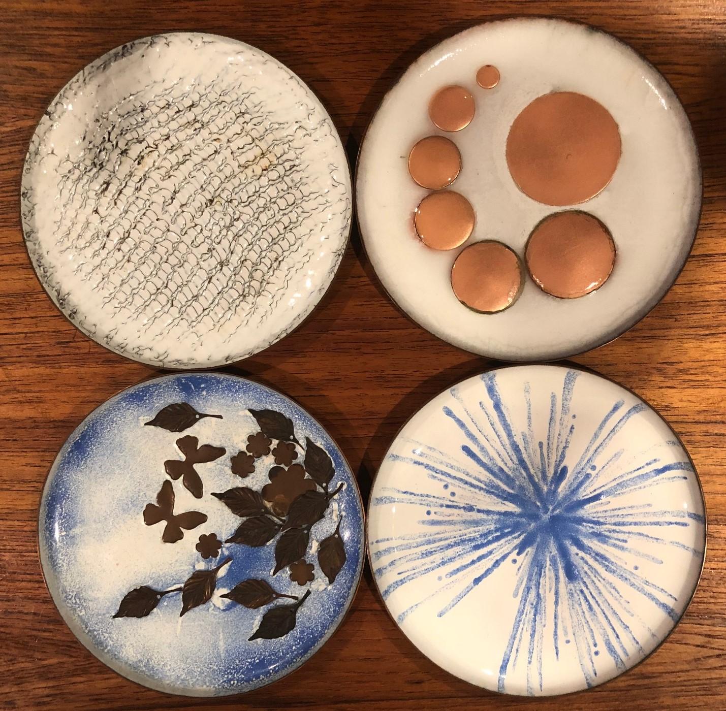 Gorgeous set of four Mid-Century Modern enamel on copper plates, circa 1960s. The plates are in very good condition and measure 5.75