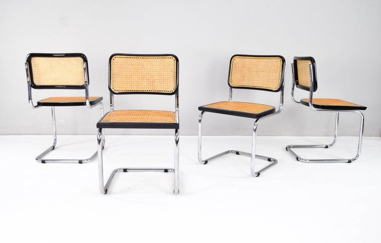 Set of four Cesca B32 chairs, Italy, 1970s.
Chromed tubular frame with signs of wear on the bottom facing the ground but in good overall condition.
Seat and back frames in black lacquered beech wood and natural Viennese grille. Both the natural