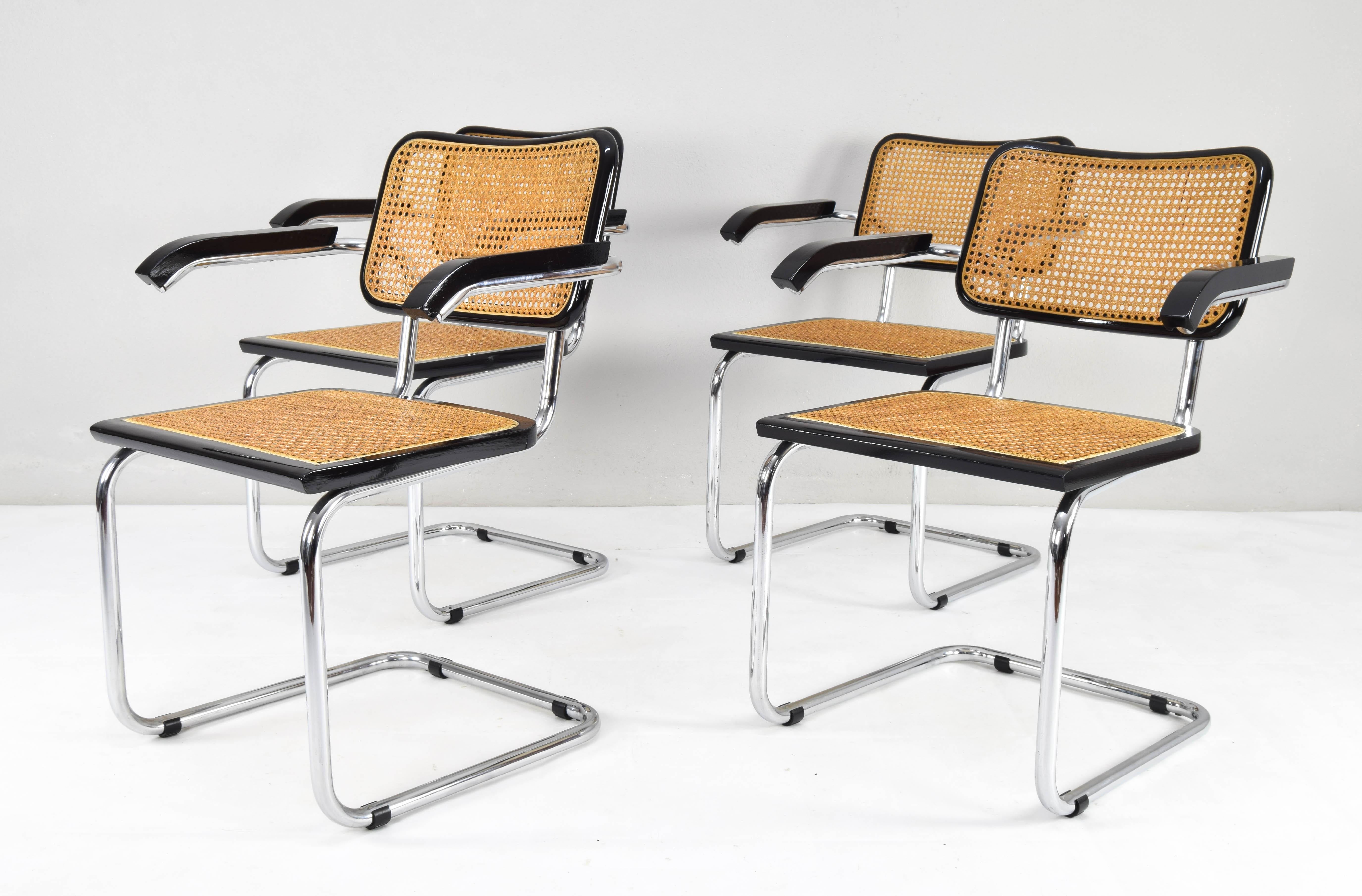 Set of four Cesca chairs model B64, with armrests. Tubular steel chromed structure in very good condition. Beechwood frames lacquered in black and Viennese natural grid. Grids of the four seats have been put new.

Measures:
Total height 83
