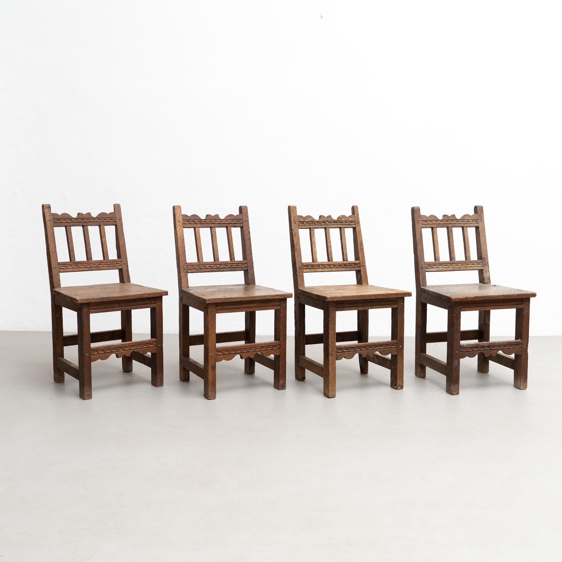 Set of four rustic wood French chairs.

Embrace the rustic charm of this set of four mid-century modern rationalist wood chairs, manufactured in France circa 1940. These chairs showcase a timeless design, making them a perfect addition to any home