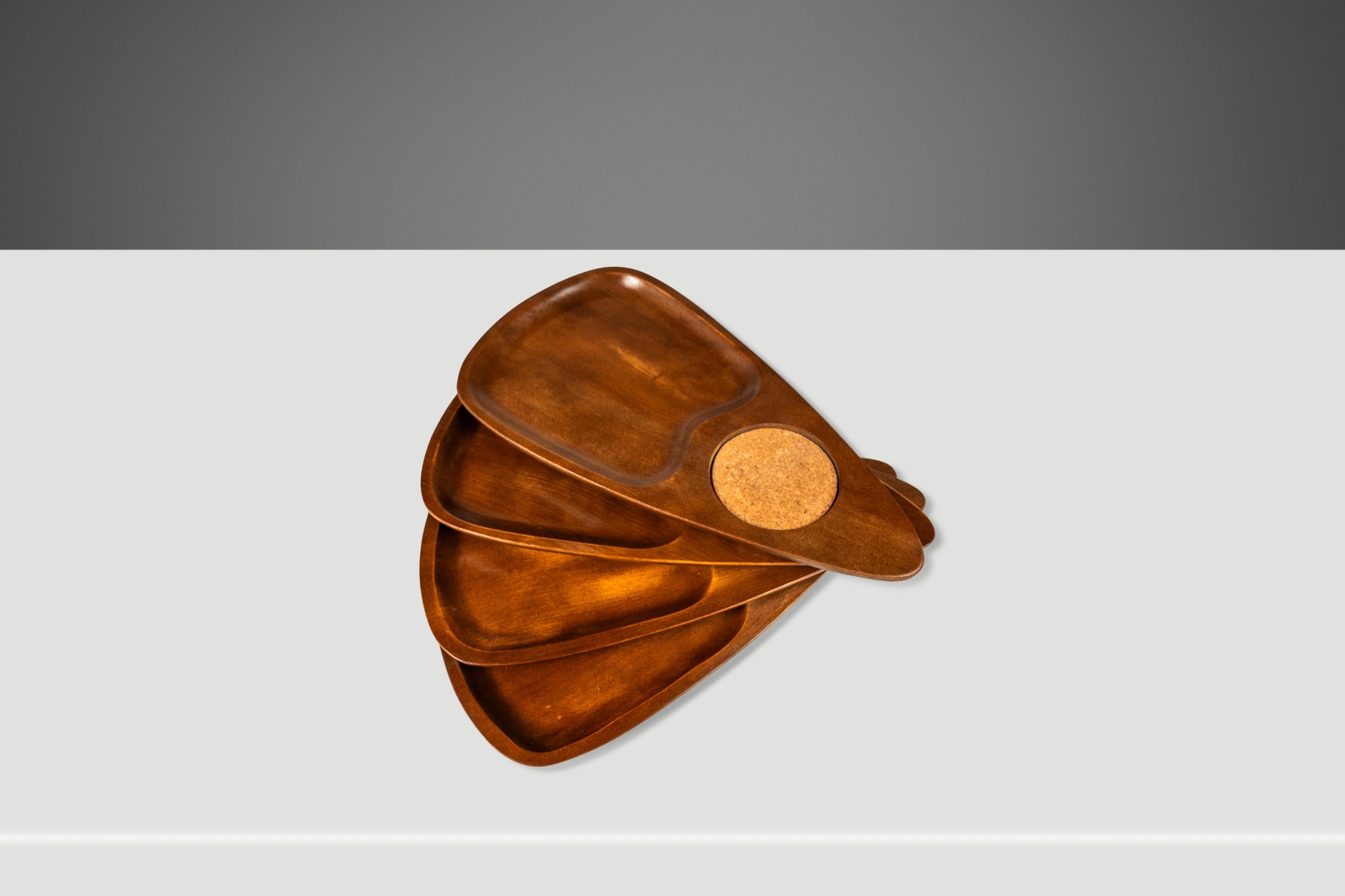 Voici un splendide ensemble de plateaux de service empilables de fabrication japonaise et de style moderne du milieu du siècle, taillés dans des plaques massives de noyer noir, avec d'exquis veinages de bois ancien. Avec des dessous de verre en