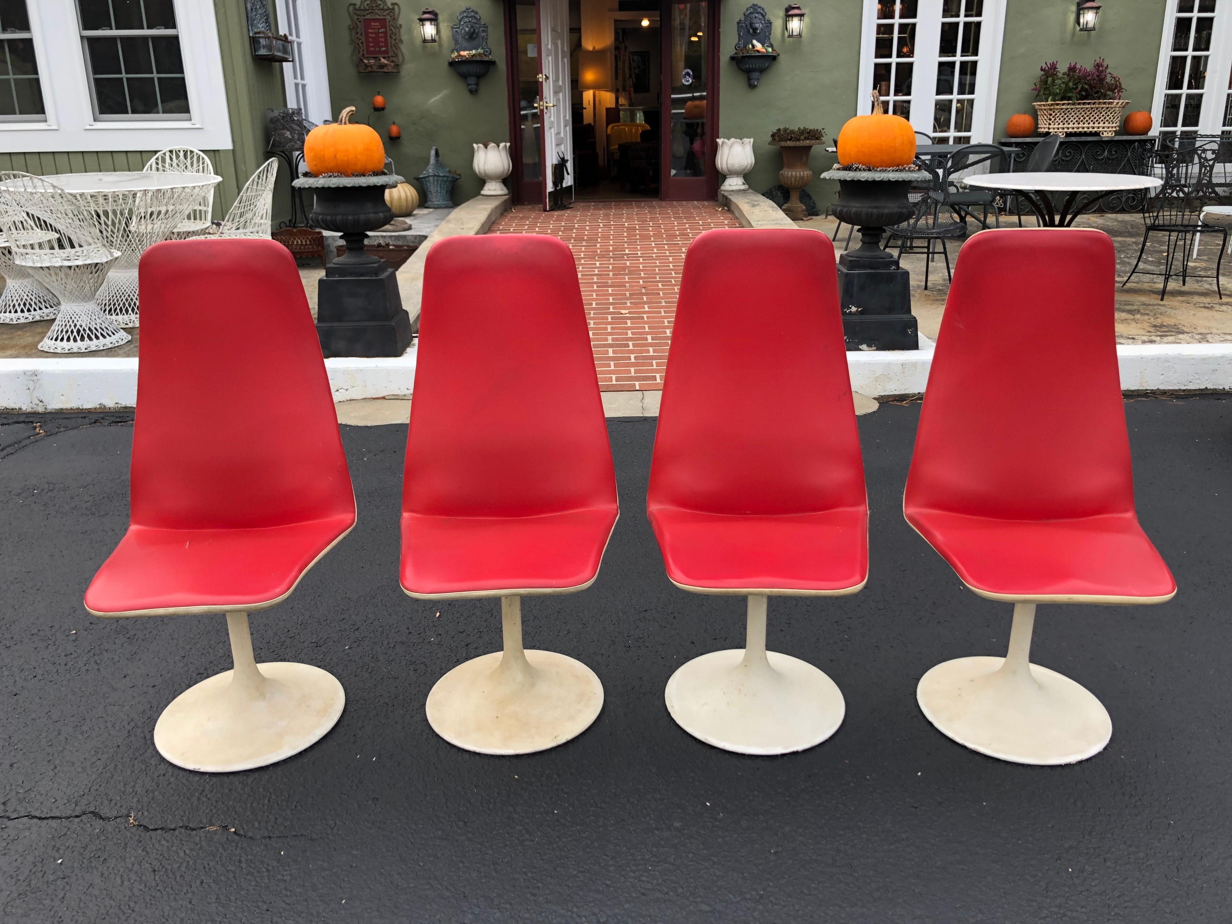 Set of Four Mid-Century Modern swivel chairs by Swedish designer Borje Johanson. In fire engine red with crème contrast. These chairs are entitled 
