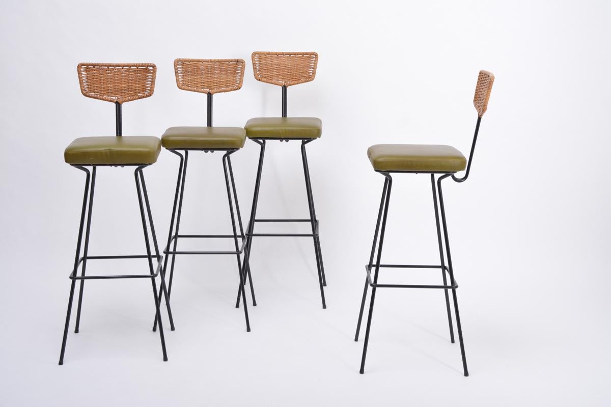Very rare set of four bar stools designed by Prof. Herta-Maria Witzemann and manufactured by Erwin Behr in Germany in the 1950s. The stools have solid metal black painted frames and handwoven cane backs, the seats are covered in green leather, very