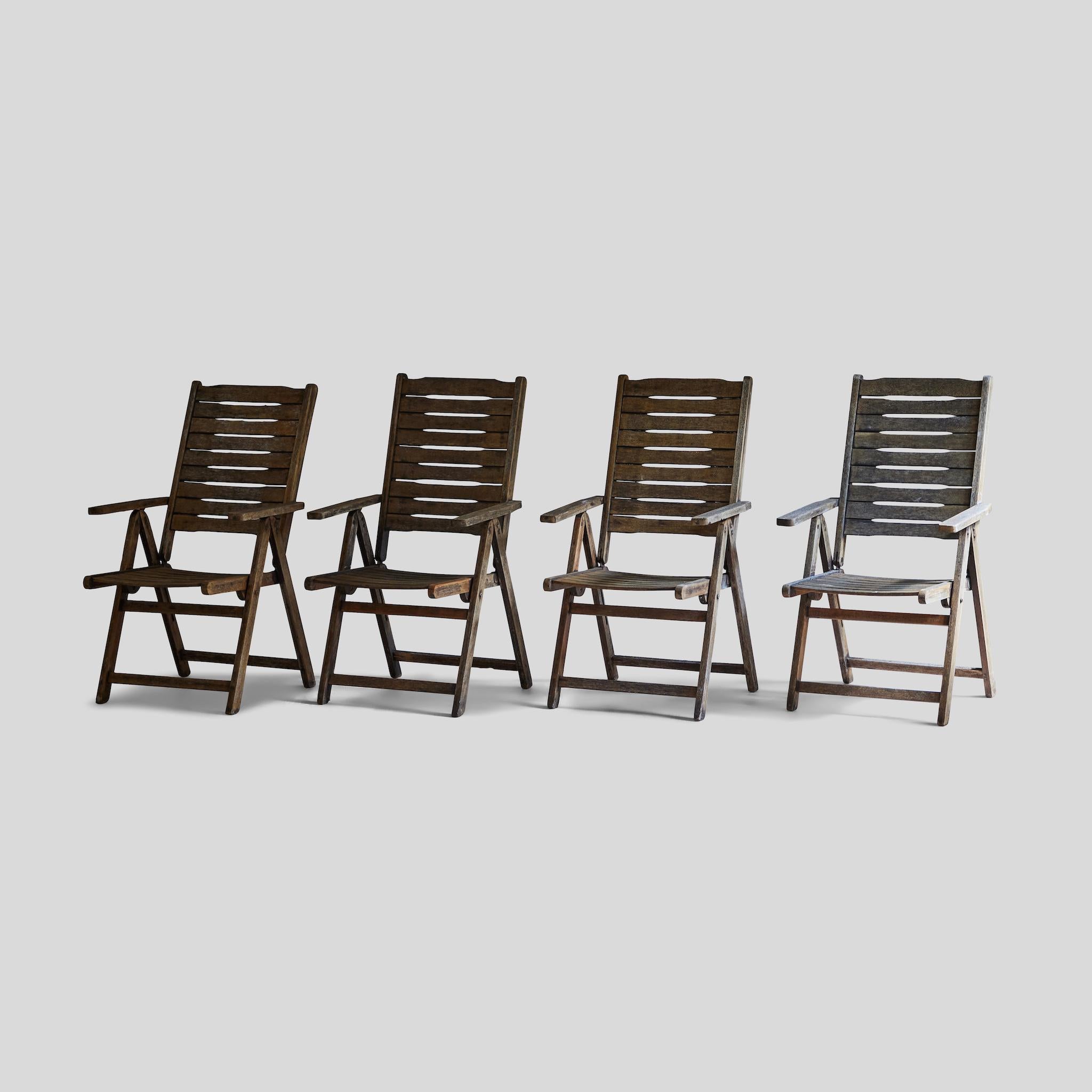 Set of four mid-century reclining lawn or patio chairs.