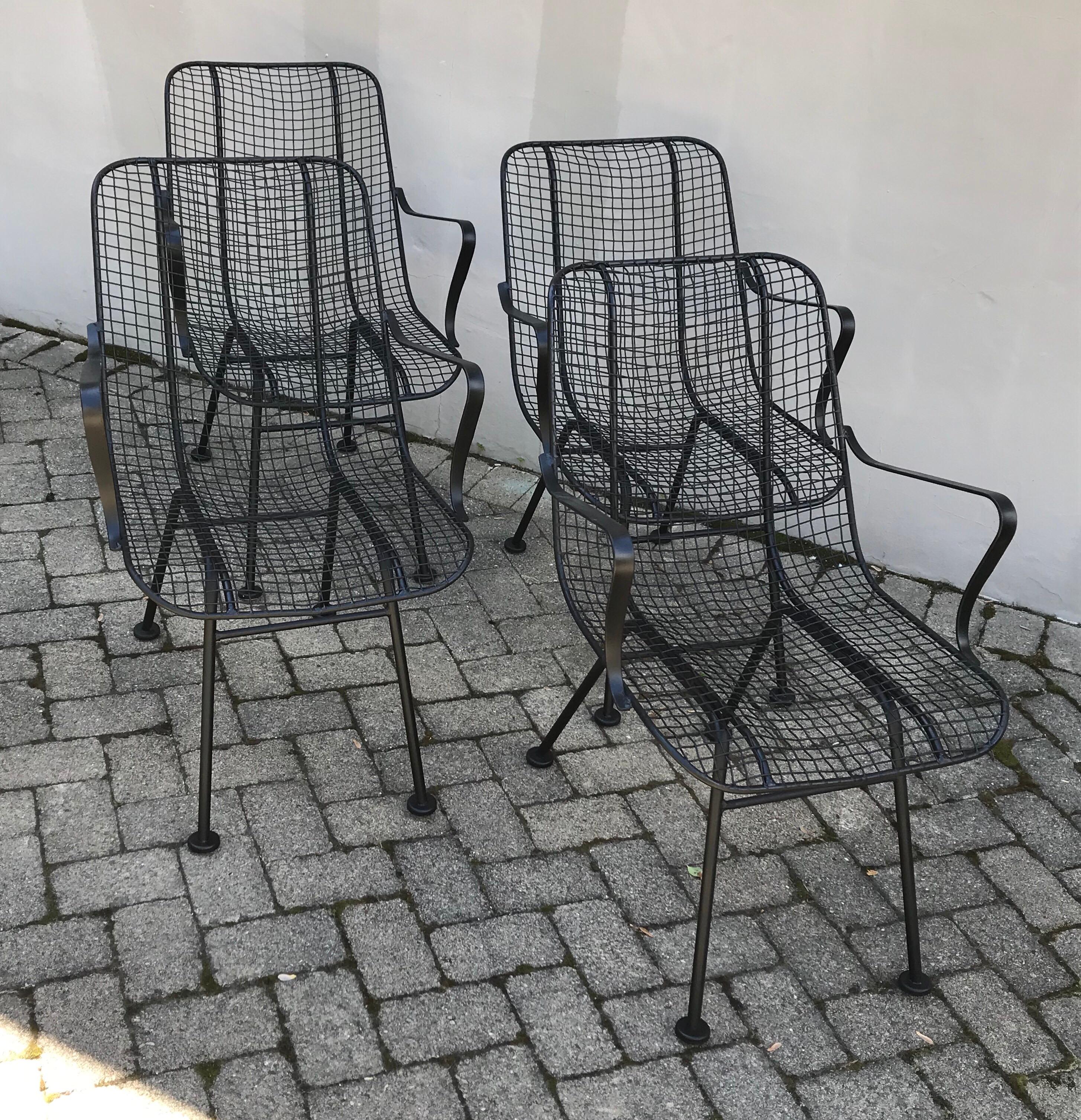 Nice set of four lounge chairs by Russell Woodward, 1960’s. Fresh matte black paint and new plastic floor protectors.