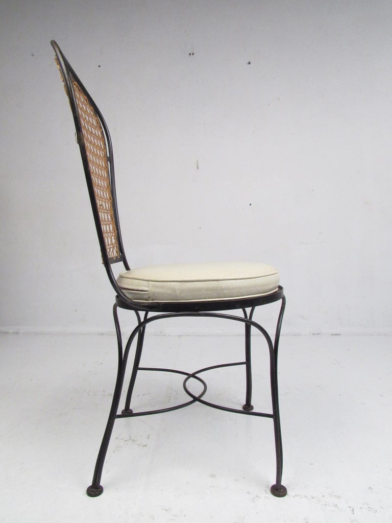 Set of Four Midcentury Wrought Iron Dining Chairs with a Cane Backrest