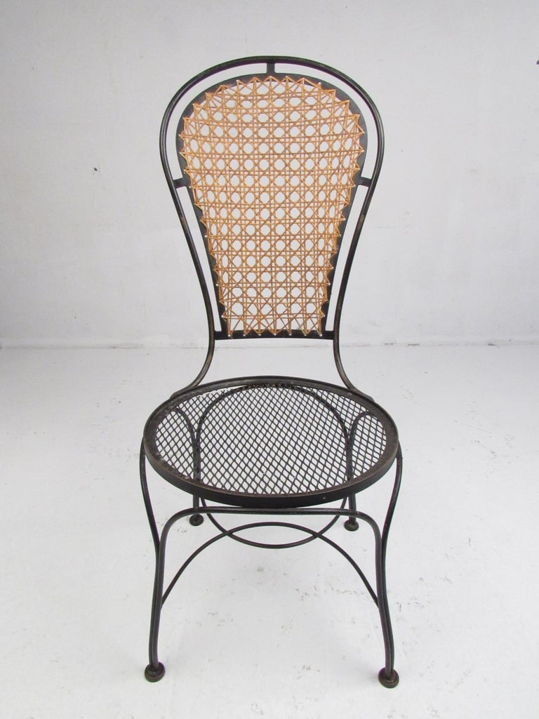Set of Four Midcentury Wrought Iron Dining Chairs with a Cane Backrest