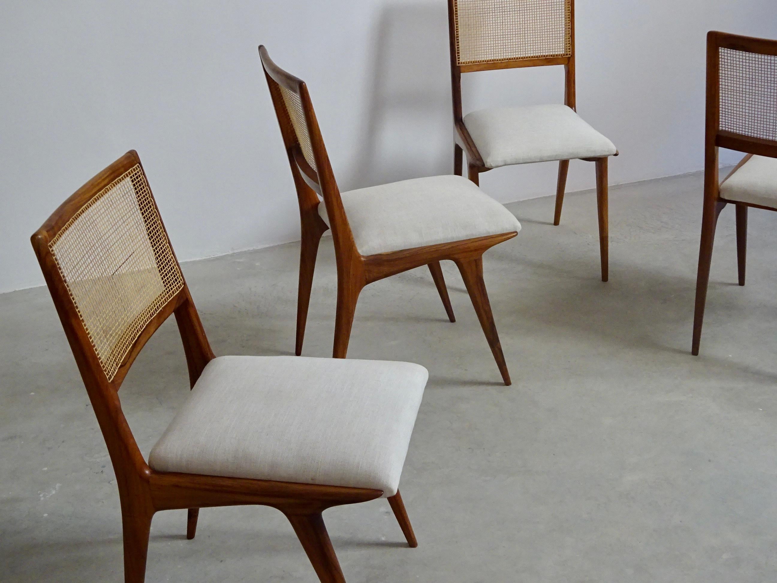 Set of four chairs in “caviúna” wood, cane and upholstery, unknown designer, produced by “Hall. Móveis e Decorações”, São Paulo, Brazil.