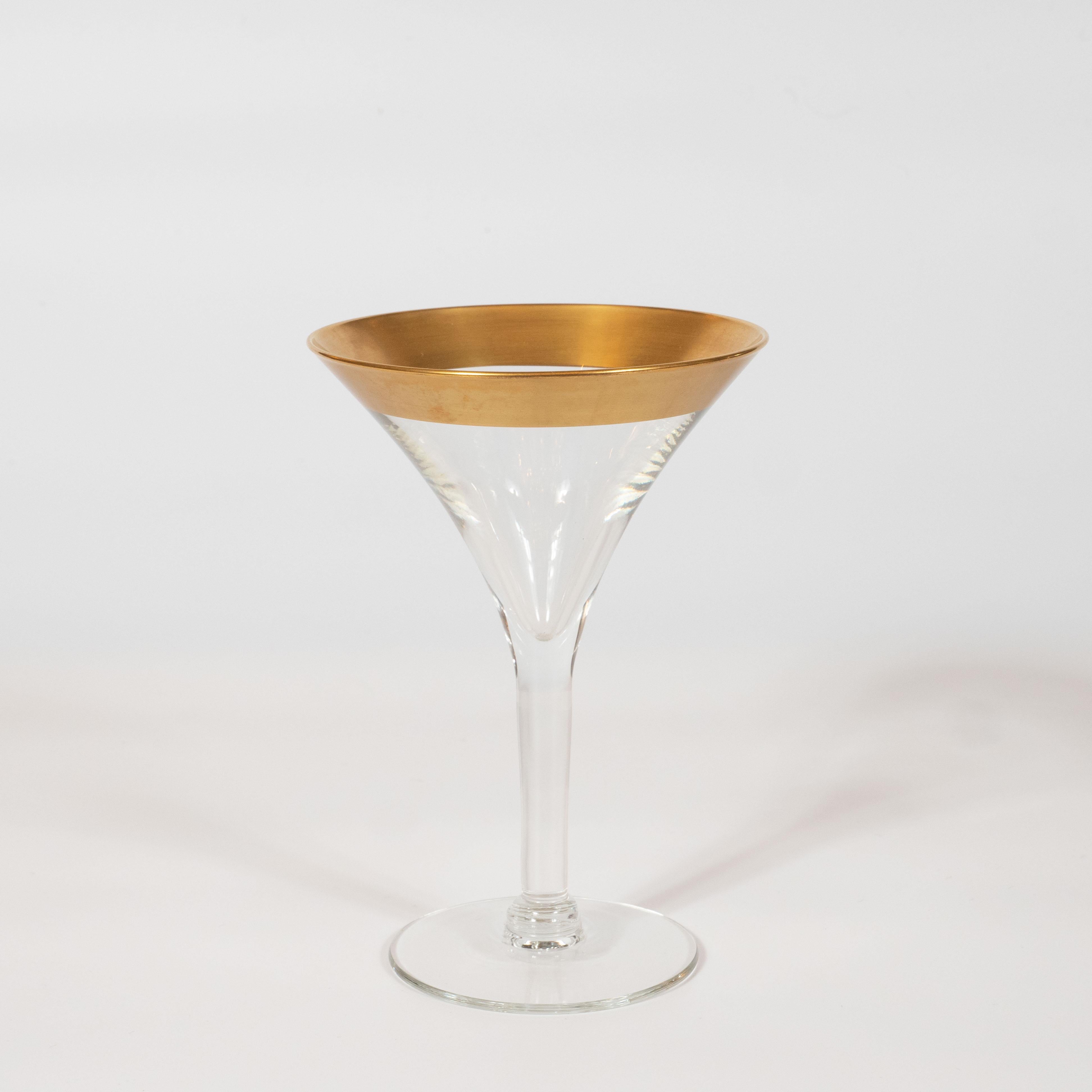 This elegant set of four champagne/martini glasses were realized by the esteemed Mid-Century Modern designer, Dorothy Thorpe, circa 1945. They feature 24-karat gold rims- an exceptionally rare and sought after edition of this iconic glasses set-
