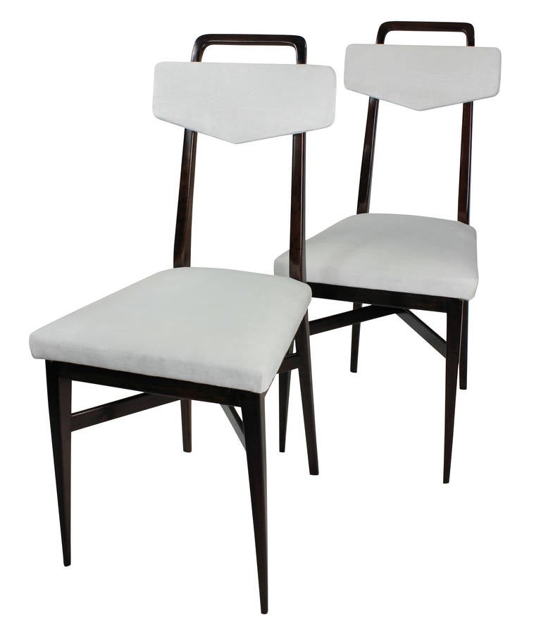 A set of four Italian kitchen chairs in the manner of Parisi in solid mahogany with over stuffed seats and backs in white velvet. With brass detail.

 