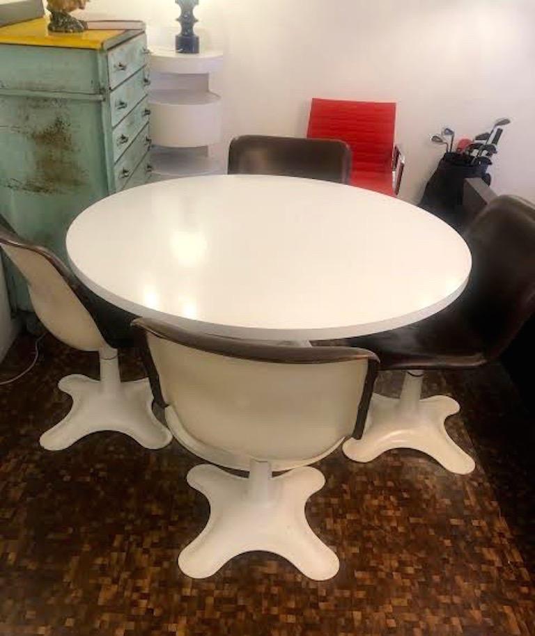 This is a very uncommon set of four dining chairs and table by Yrjö Kukkapuro for Haimi in Finland, circa 1960s. Swivel bases. 100% original. All chairs are labeled.
All the chairs are in the original brow leather. The white finish on the cast