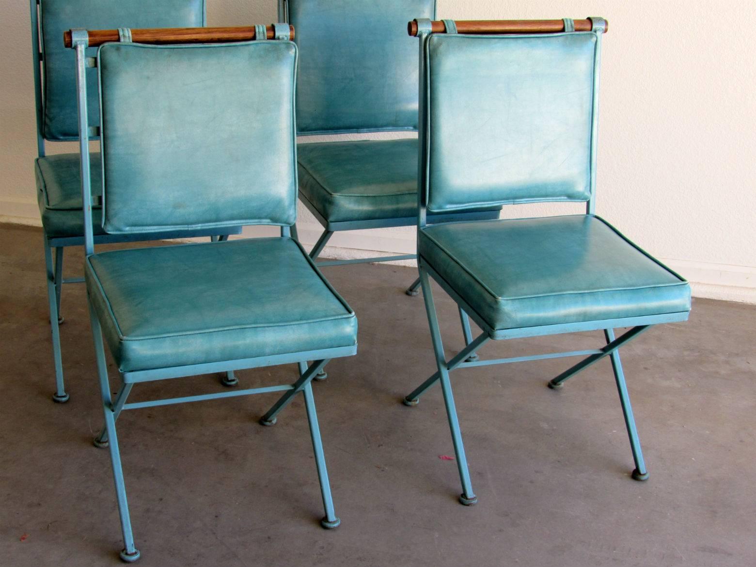 Set of four modernist campaign dining chairs designed by Cleo Baldon for Inca Products - Santa Fe Springs, Ca.  All original vintage iron and teal blue naugahyde upholstery with beautifully aged patina color - circa 1960s. 