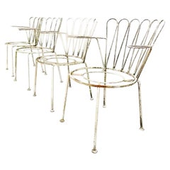 Set of four Midcentury rustic cast iron garden chairs in white.