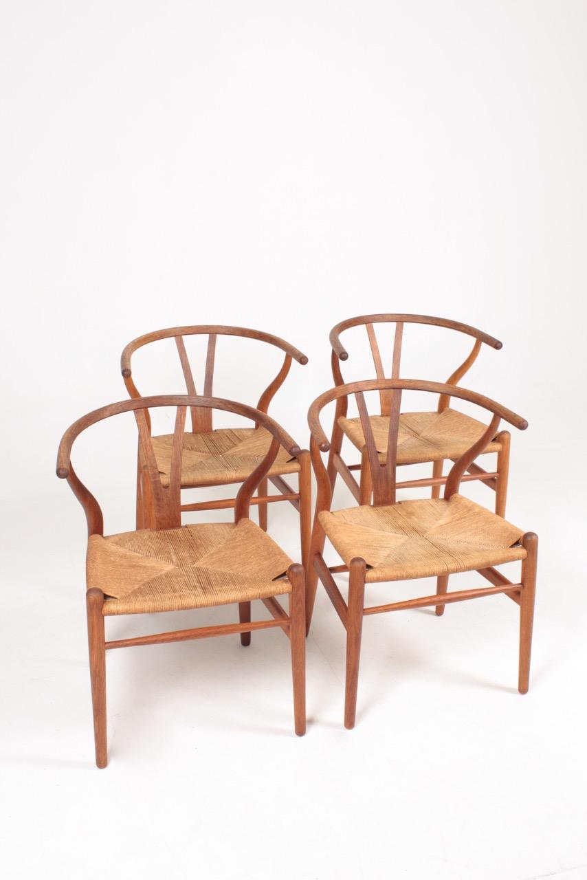 Set of four wishbone chairs in oak and paper cord designed by Hans J Wegner. Great original condition.