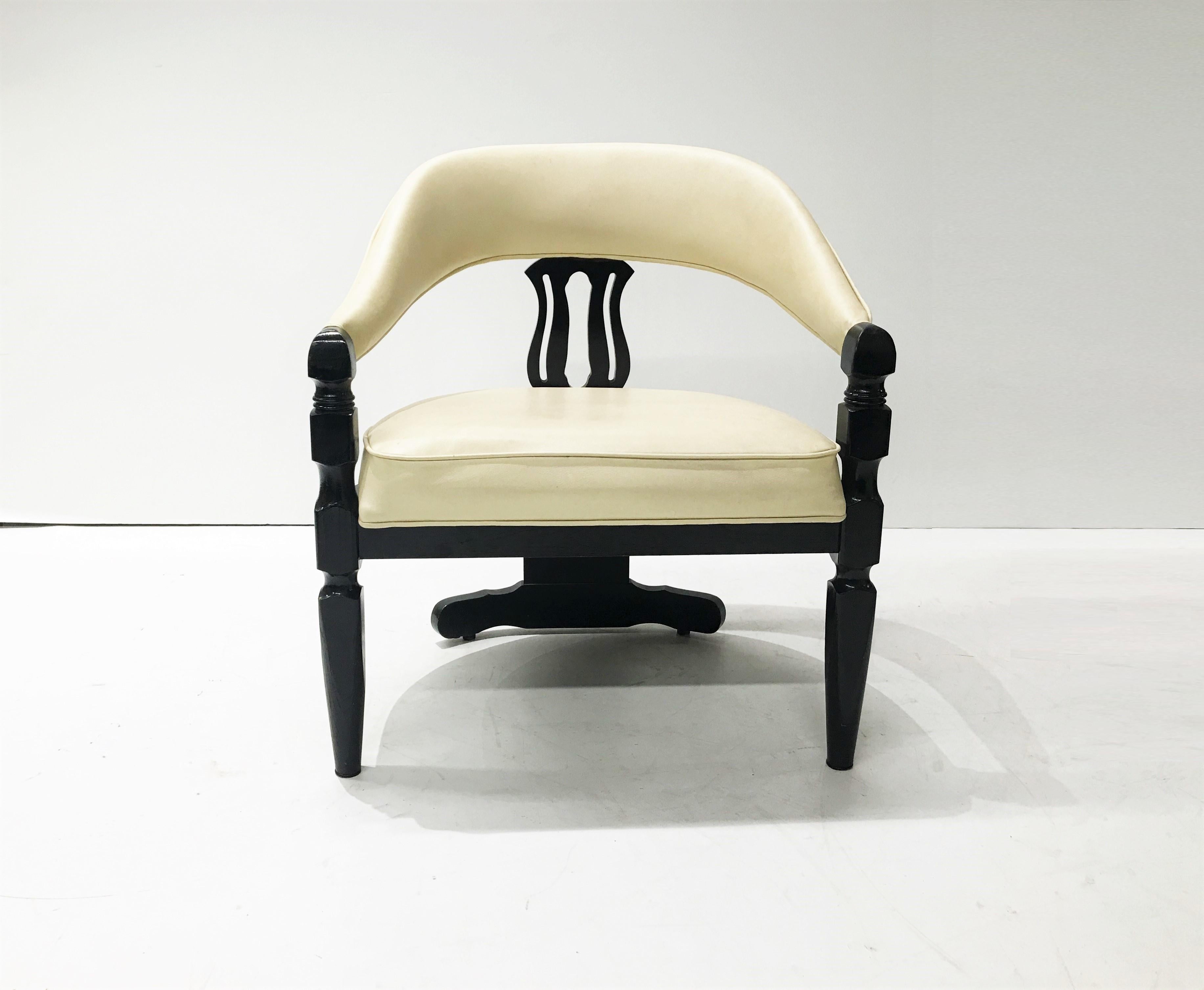 Four Mid-Century Modern Chinese inspired 3-legged armchairs. The low profile armchairs have wood frames in dark black finish and upholstered in off-white vinyl. The upholstered form is powerful with its’ robust sloped arm rails that terminate in