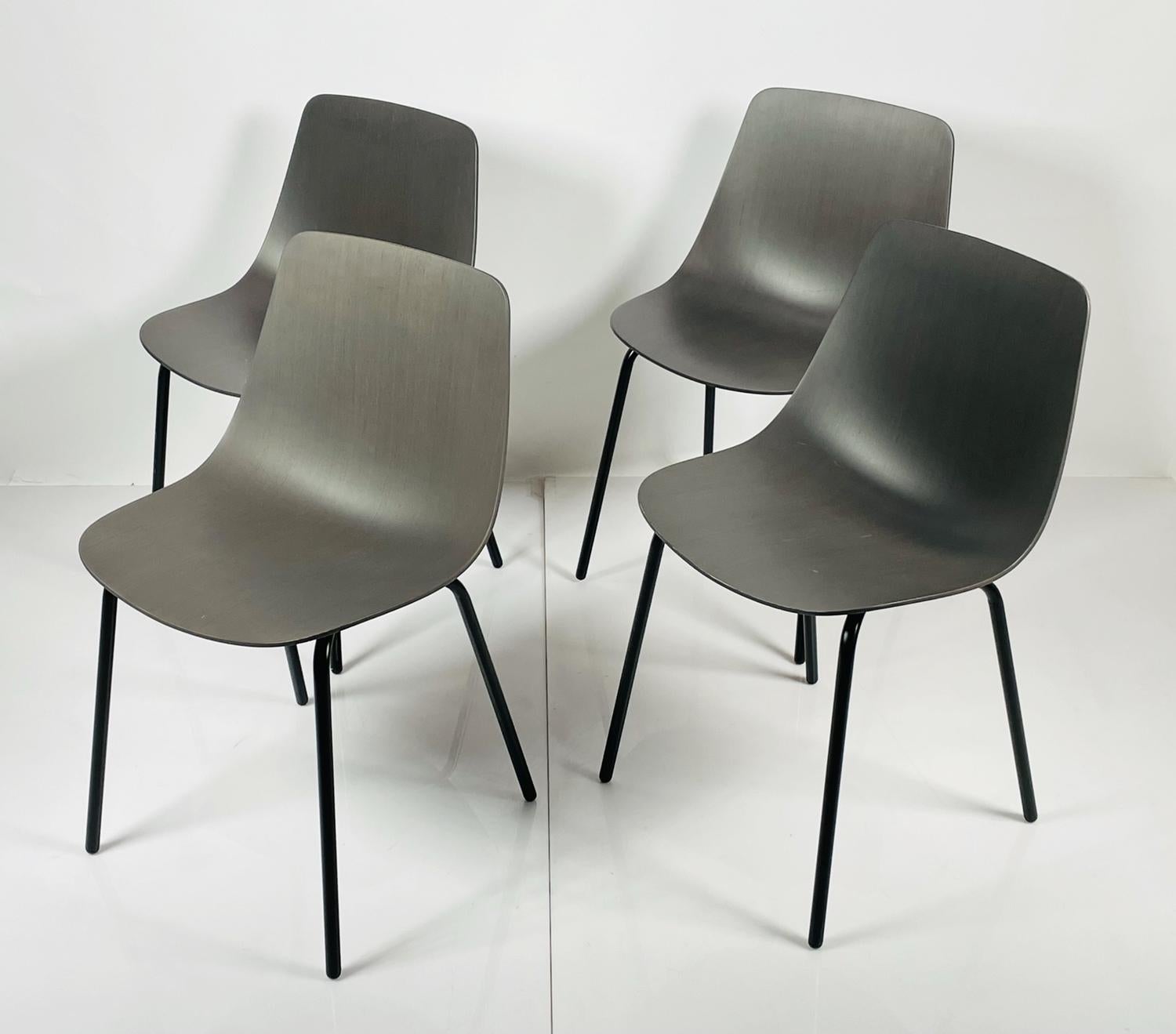 Set of four modern chairs having a molded plywood seat and metal legs with a black powder-coat finish.

Measurements:
31 inches high x 18 3/8 inches wide x 18 3/4 inches deep x 17.50 inches seat height.