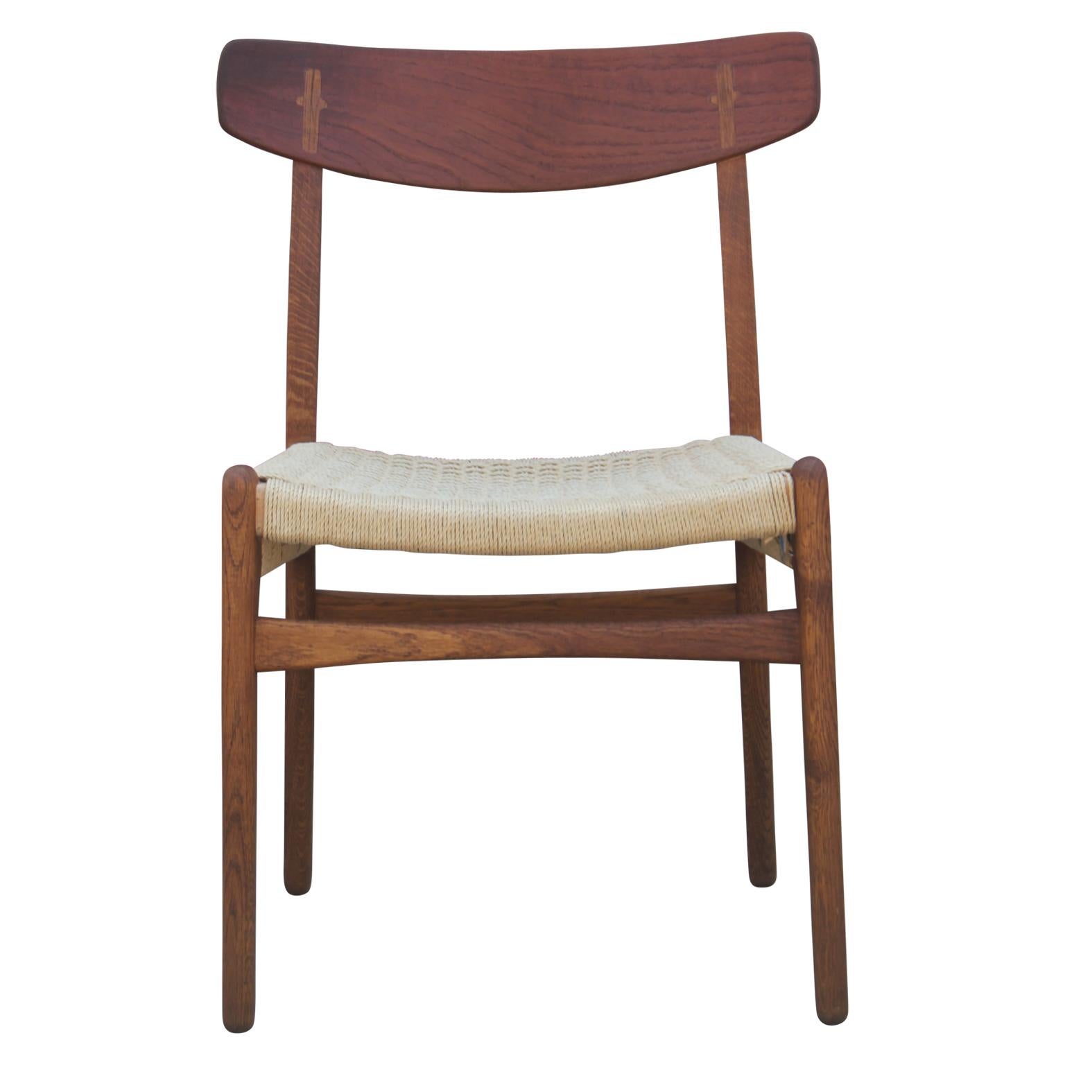Set of four teak and woven cord dining chairs designed by Hans Wegner in 1951 and produced by Carl Hansen & Søn. Model number CH23.