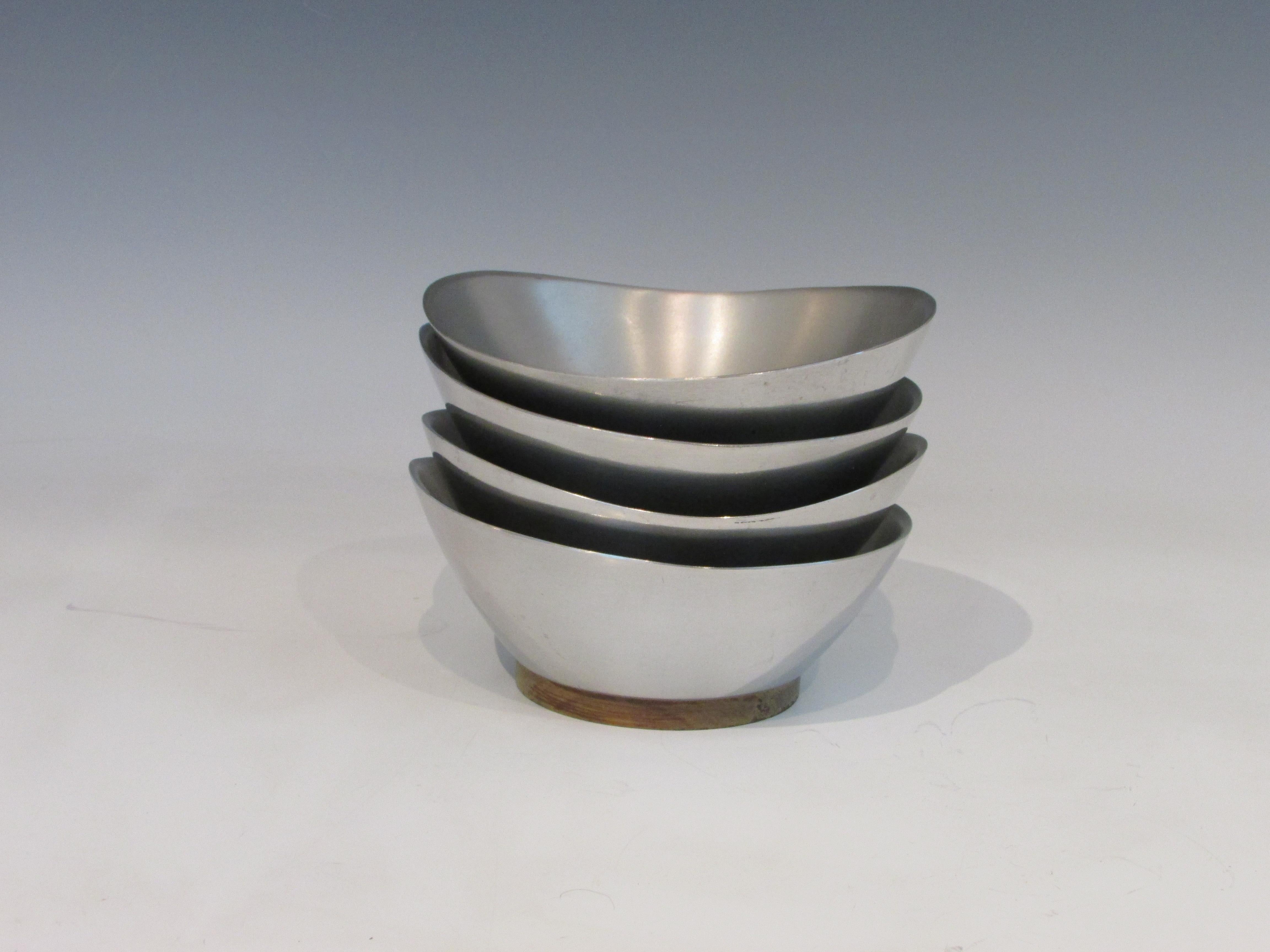 Cast aluminum serving bowls in bio morphic shape with walnut bases. Set of four.