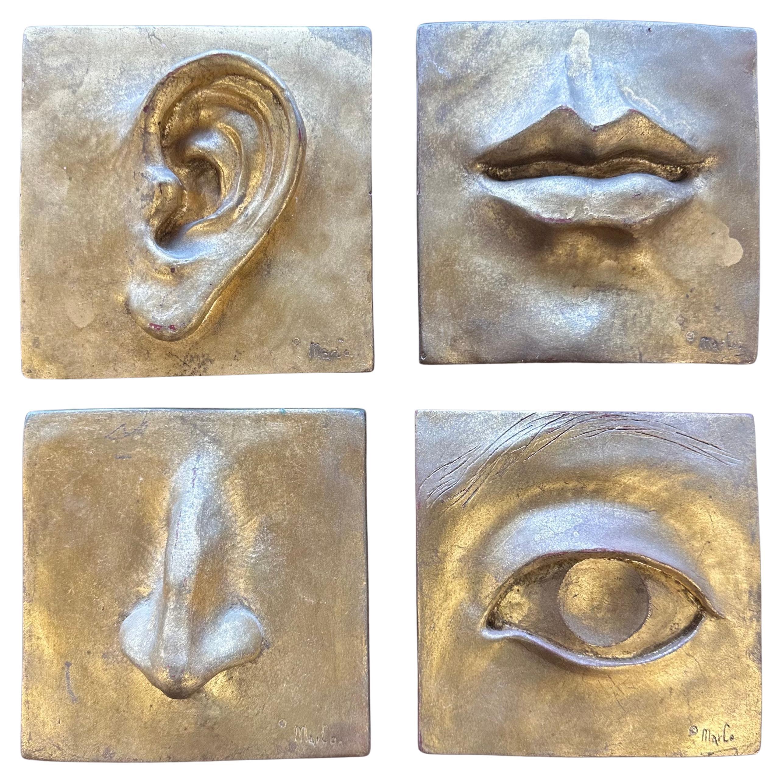 Ensemble de quatre plaques murales modernistes "Face" en or doré par Marlo pour MAC en vente