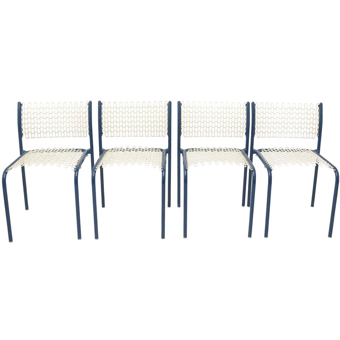 Set of four modernist indoor/outdoor blue metal framed chairs with cream mesh metal PVC coated seats and backs.