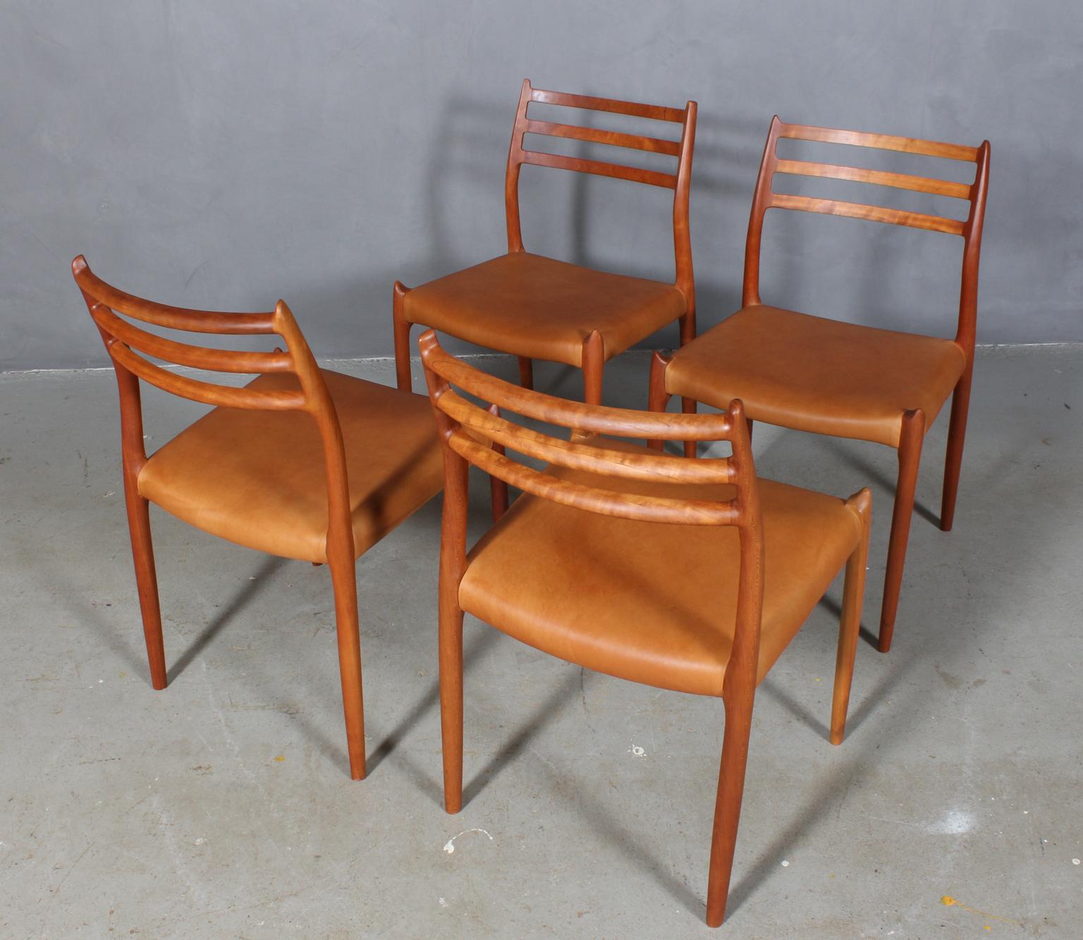 Set of four N. O. Møller dining chairs with frame of solid cherry.

Seats new upholstered with vintage tan aniline leather

Model 78, made by J. L. Møller, Denmark, 1960s.