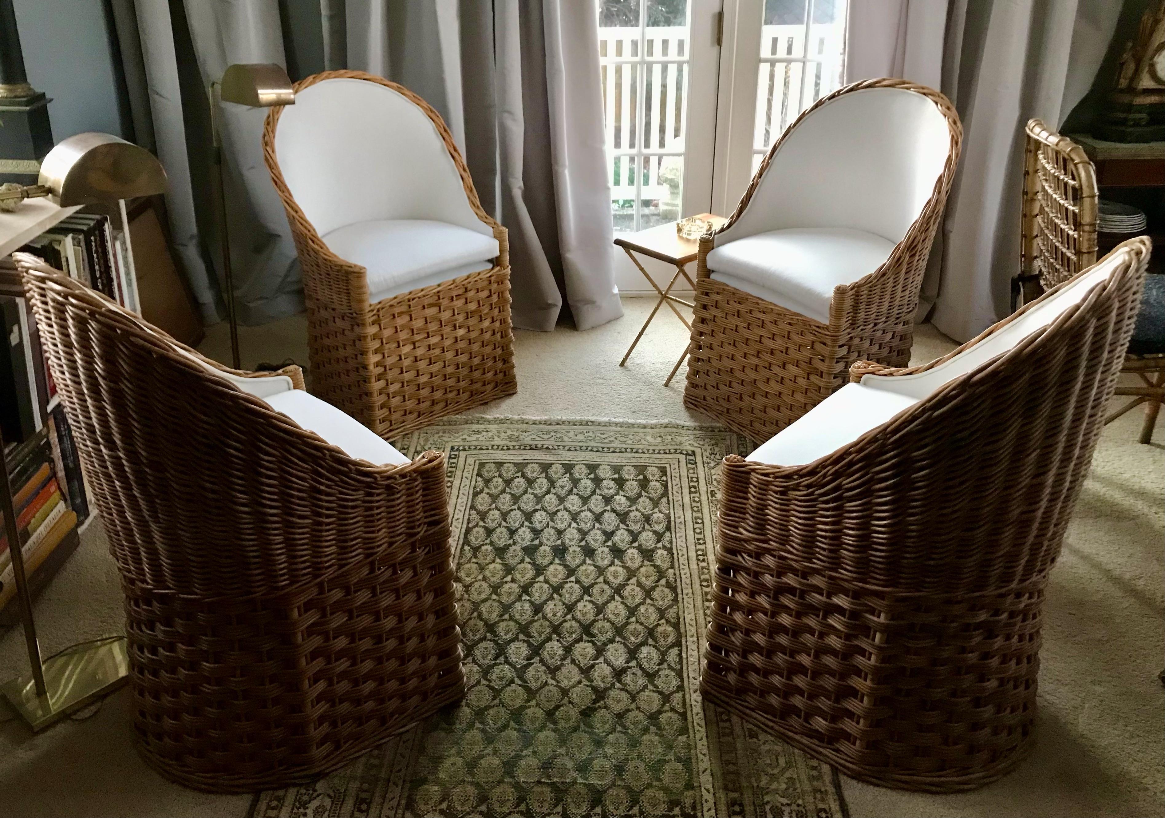 Set of four natural wicker barrel back chairs. Four mid-century woven wicker/rattan barrel back side chairs newly upholstered in white muslin; ready for the game room in Connecticut or in the pool house on Long Island. United States, mid 20th