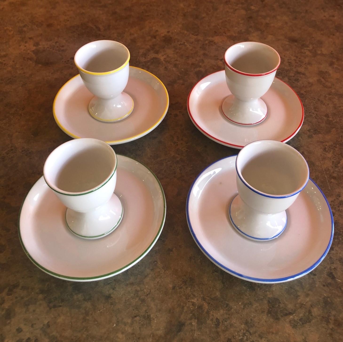 Stylish set of four Neiman Marcus egg coddlers with under plates, circa 1980s. The set is 
