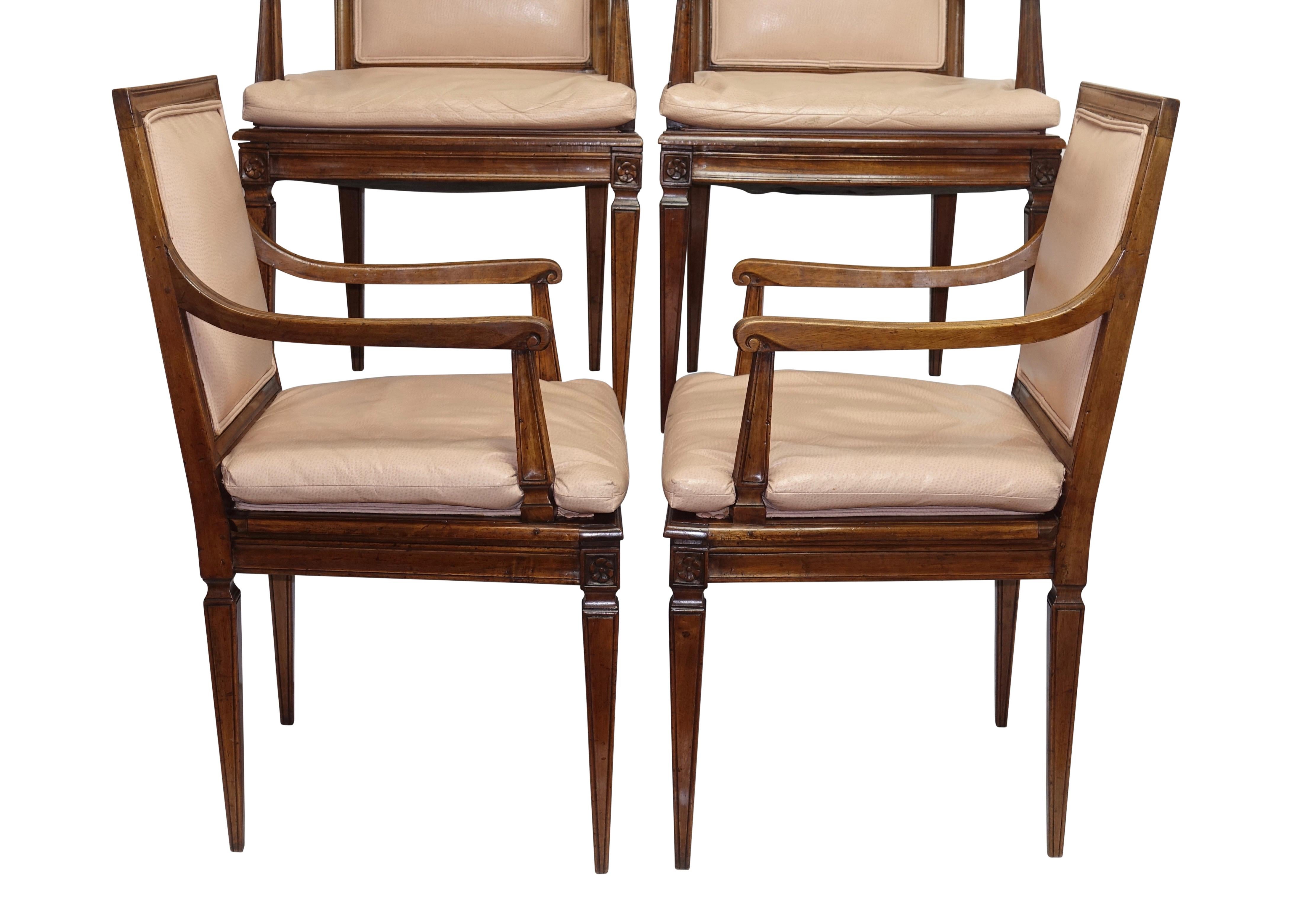 A set of four neoclassical style beechwood armchairs with sculpted frame and standing on tapering square legs, with leather upholstery. Italy, late 19th-early 20th century.