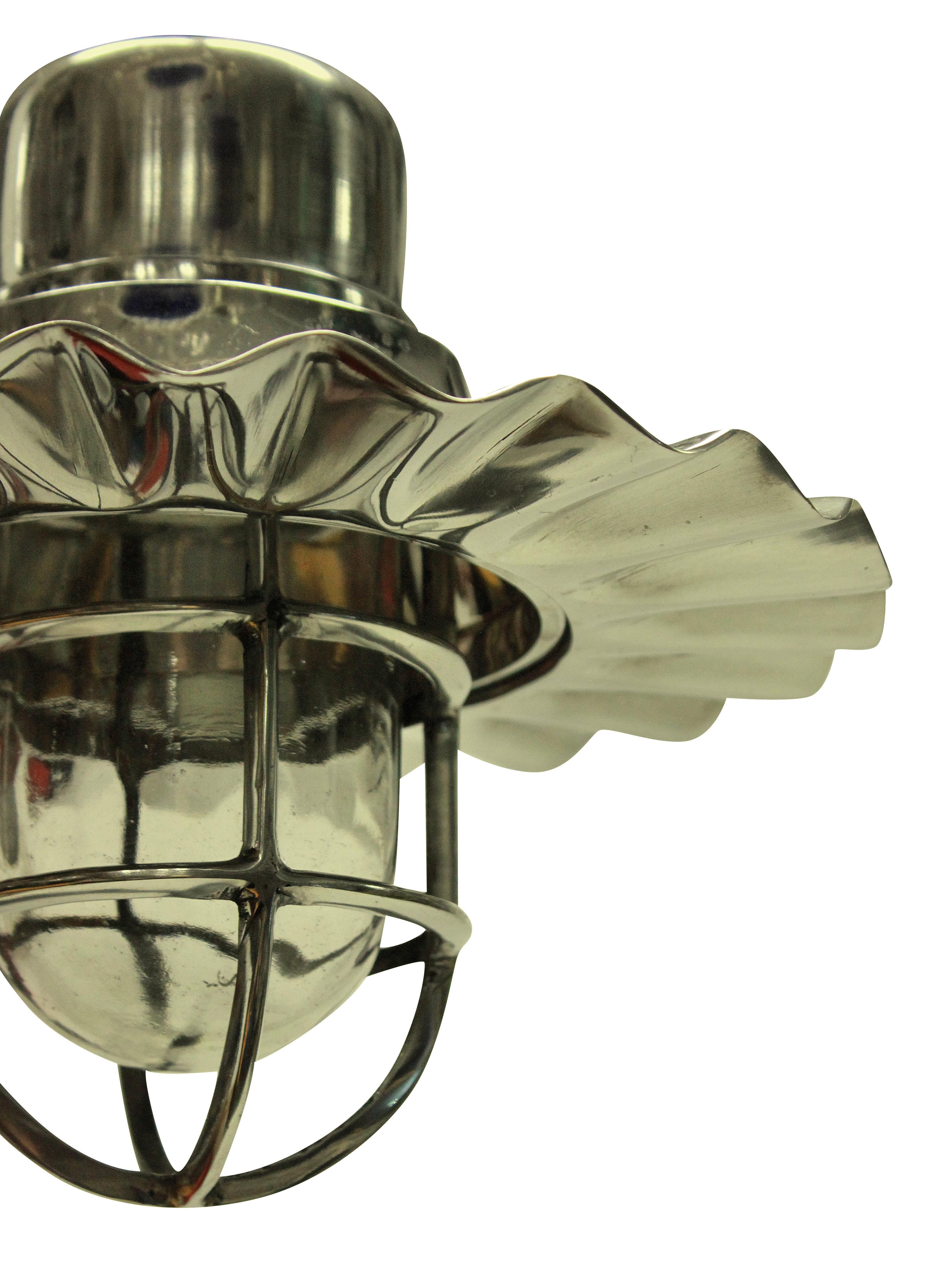 A set of four ship's hanging lights in nickel plate. With an interior glass case housing the light bulb.