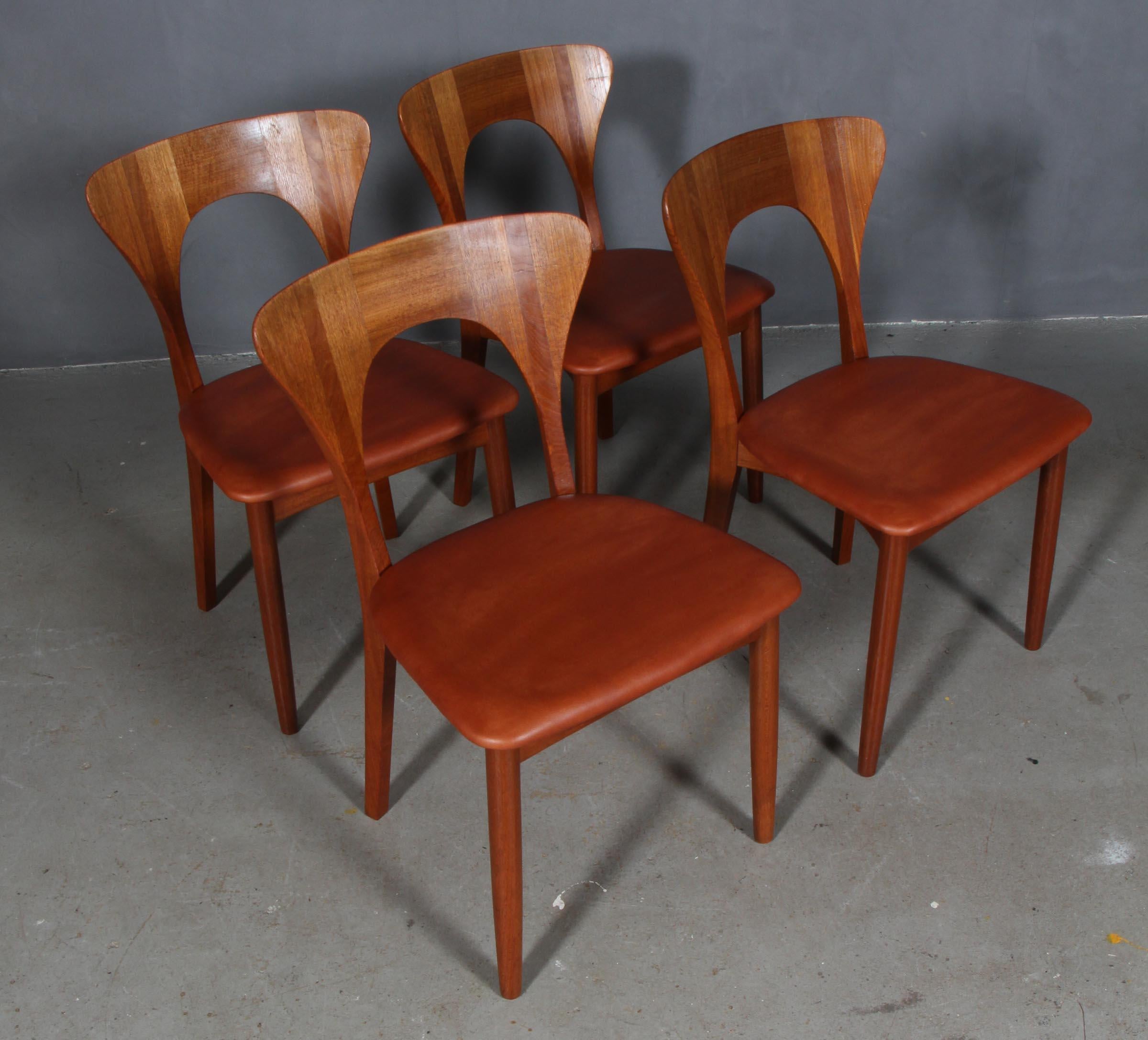 Set of four Niels Koefoed dining chairs in massive teak.

Model: Peter

Upholstered with cognac aniline leather.

Made by Koefoeds Møbelfabrik.