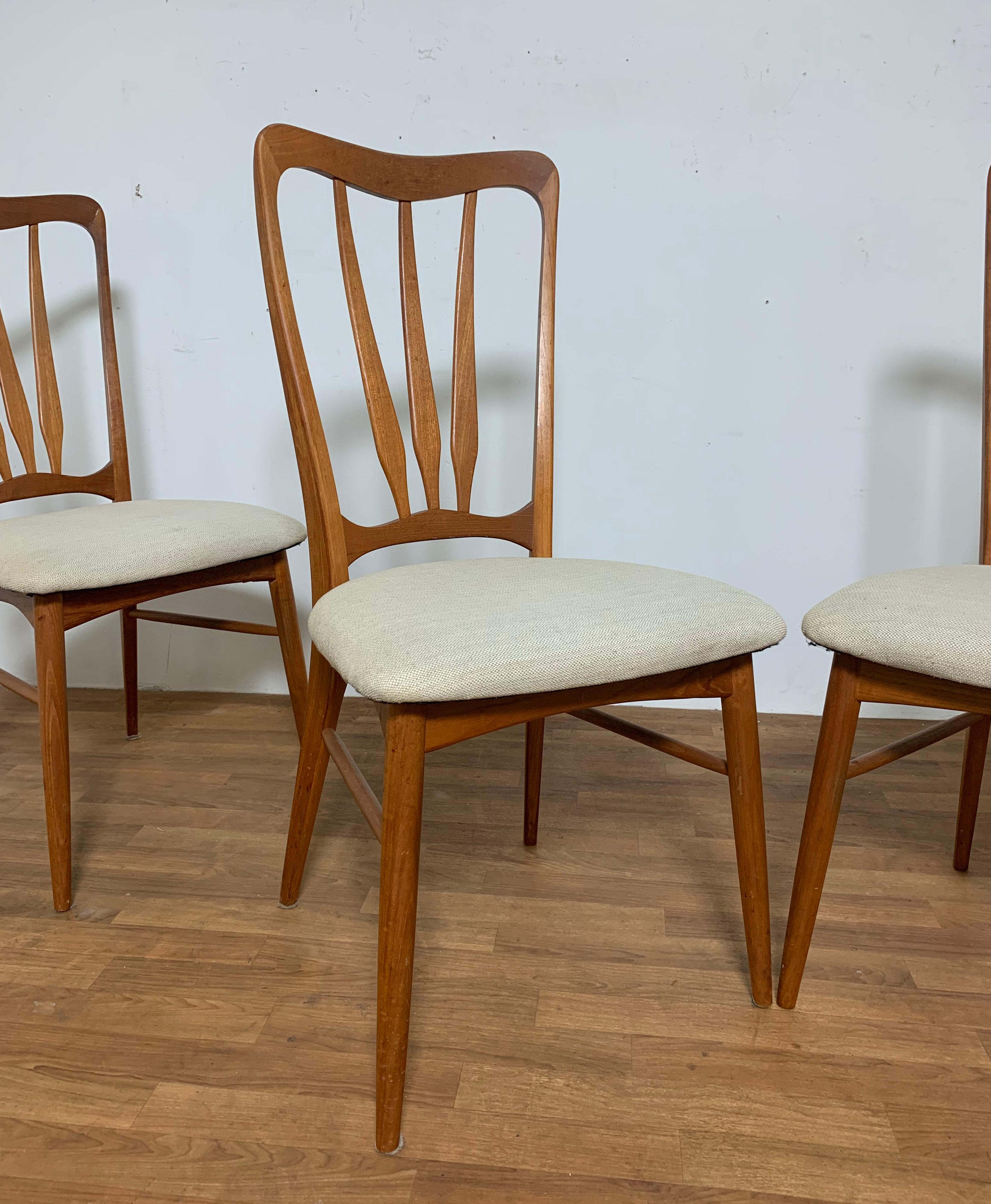Set of four teak high back dining chairs with gracefully carved fan backs by Niels Koefoed for Koefoeds Hornslet, Denmark, known as the model 