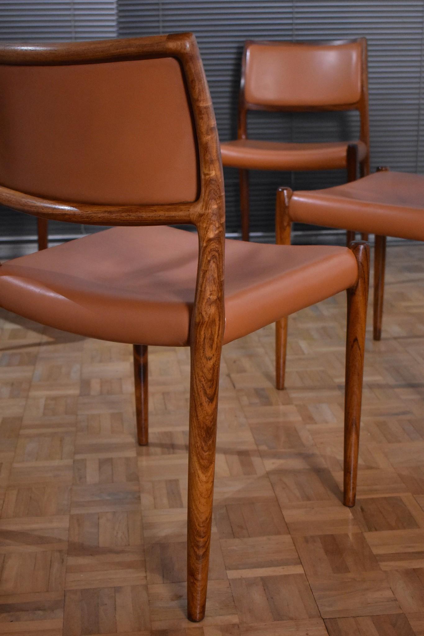 A very nice set of four Model 80 chairs designed by Niels Moller in 1968.

These chairs from the early 1970s feature particularly nice tan leather which has wonderful patina and contrasts beautifully against the rosewood frames.