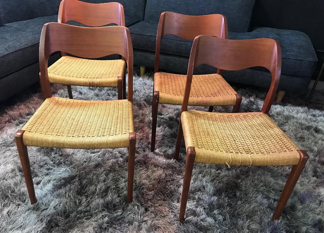 A beautiful set of four cleanly designed dining chairs by famed 20th century Danish designer Niels Otto Møller. Simple, yet elegant. Originally designed in 1951. This set still retains the original paper cord, which need some light restoration on