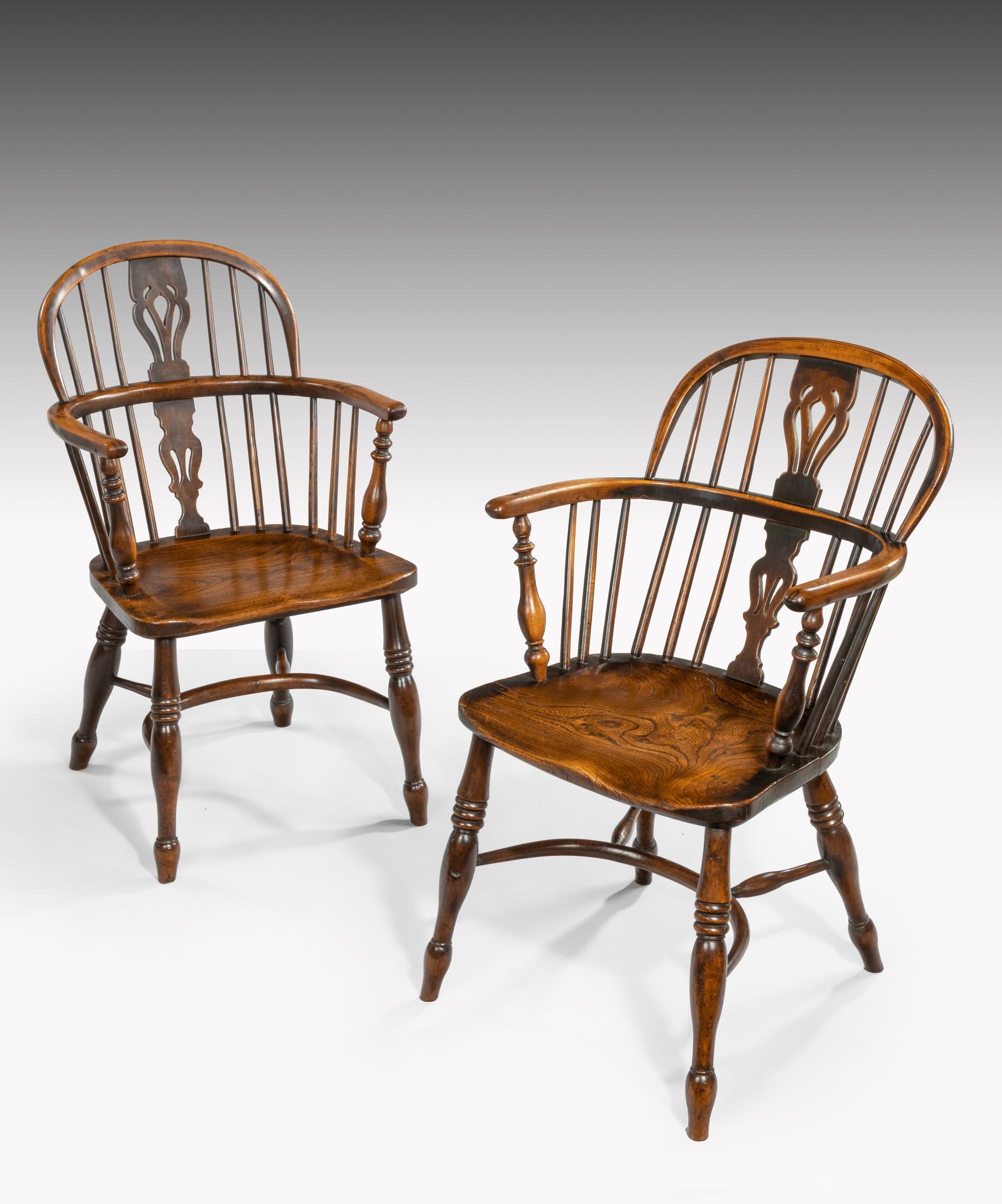 A Harlequin set of four 19th century yewwood and elm windsor armchairs; the windsor armchair's hooped back with a central pierced yewwood splat above a shaped elm seat; raised on ring turned legs united by an H-stetcher.

The windsor armchairs