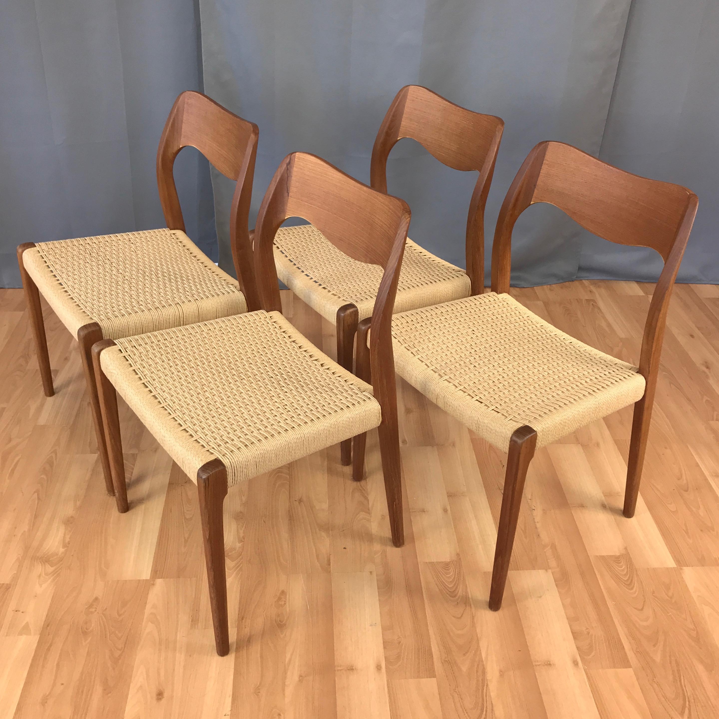 A set of four 1950s model 71 teak dining chairs with papercord seats by Niels Otto Møller for J.L. Møllers Møbelfabrik.

A timeless and essential Danish modern design classic in solid teak with ergonomically sculpted undulating back and new woven