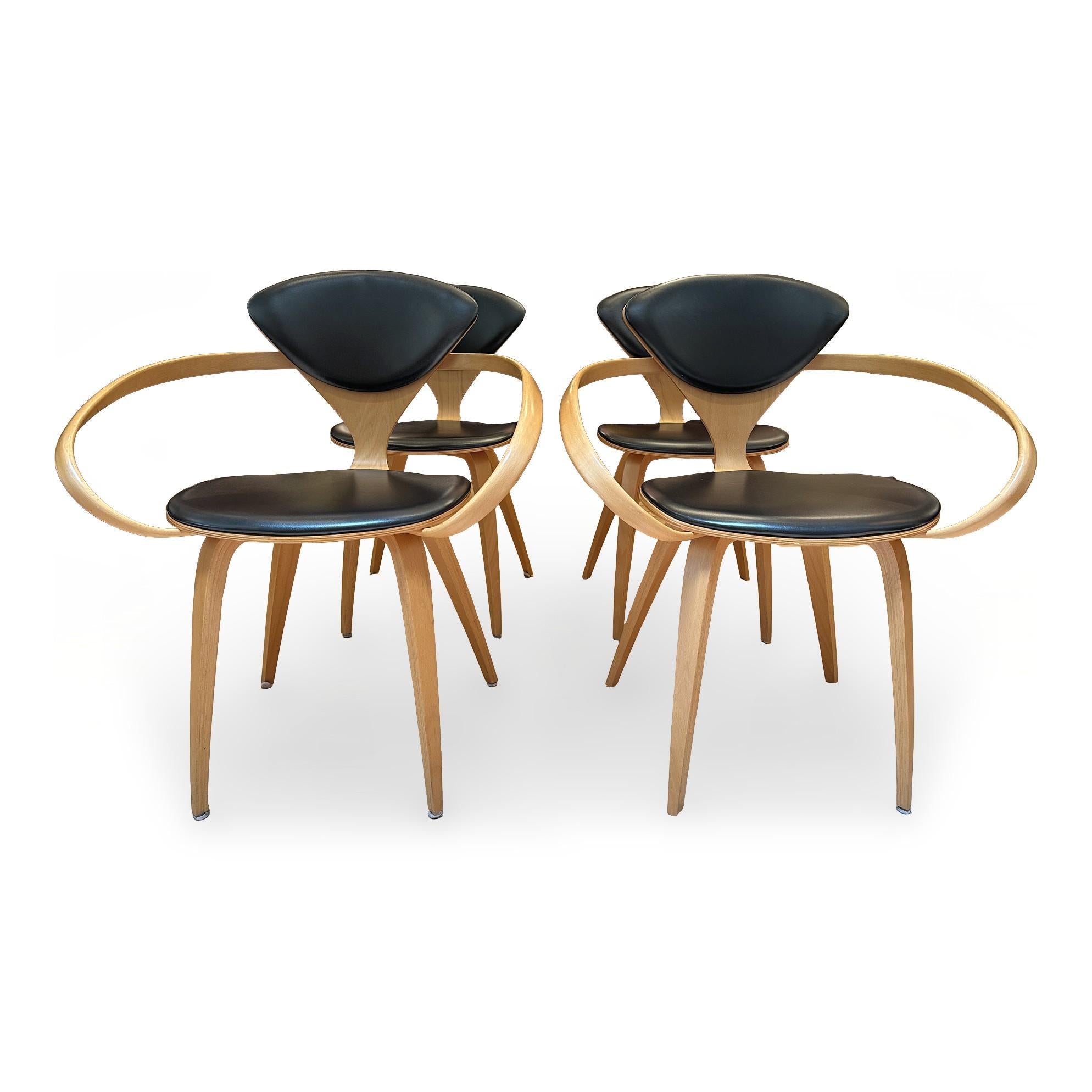 Set of four walnut dining chairs by Norman Cherner. Originally designed by Cherner for Plycraft in the 1950s, these particular chairs are manufactured in 2007 by the Cherner Chair Company of Westport, Connecticut, the sole licensor of Norman Cherner