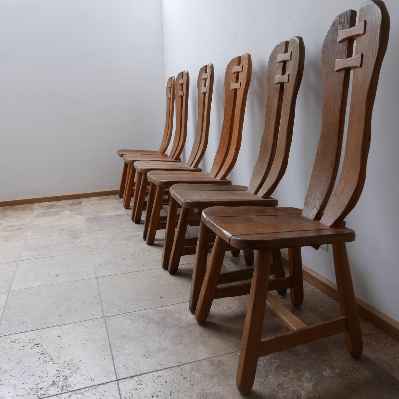 A rare Belgium dining chair set by De Puydt. 

Brutalist design from c1960s in oak. 

Solid, comfy and stylish. 

Note: Only four chairs remain, but we can possibly source more upon request. 

Good condition, some small variations in colour,