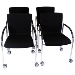 Set Of Four Office Chairs In Black Fabric With Wheels