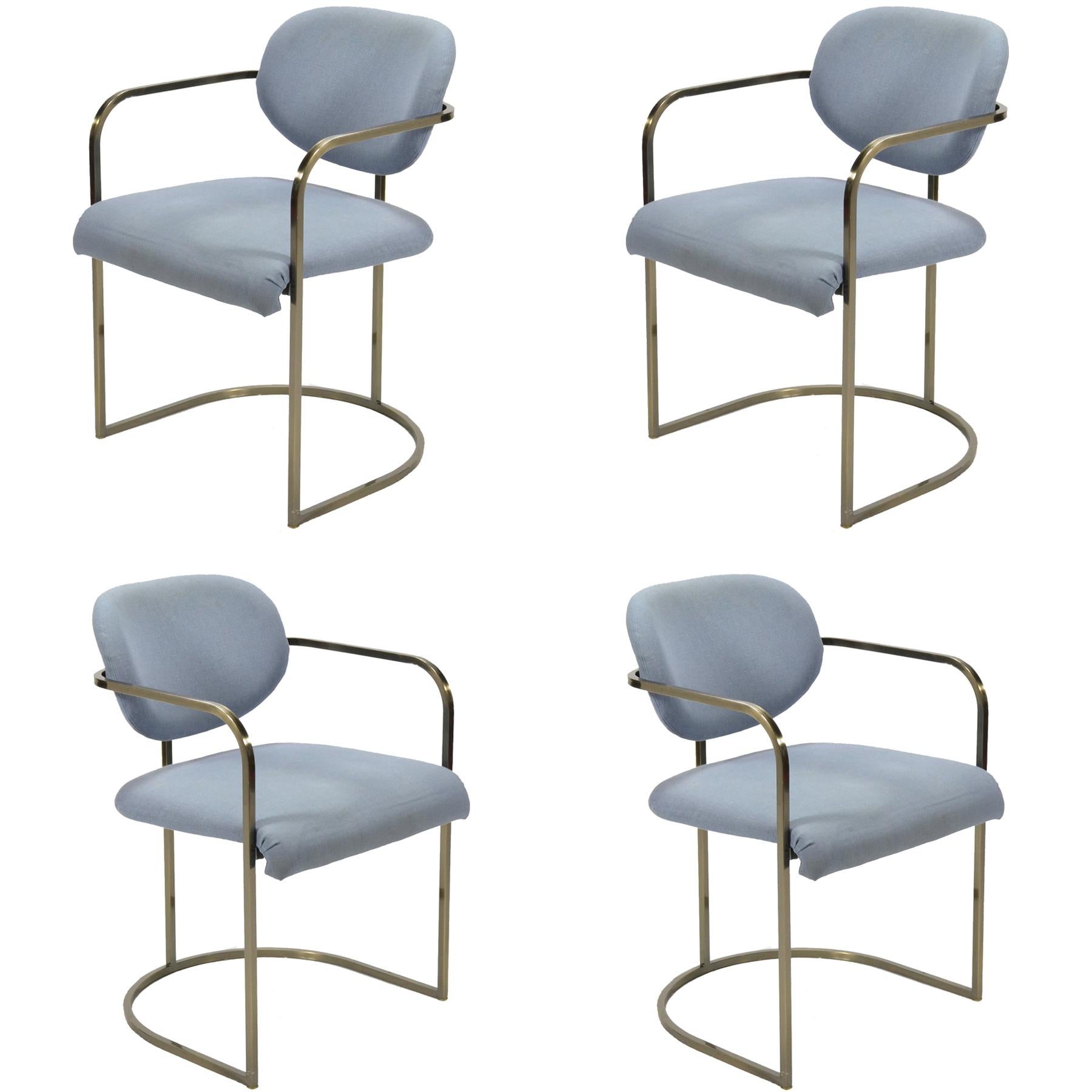 This set of armchairs by D.I.A. have frames of steel with an antiqued brass finish which support seats and backs and give them a floating appearance. They share a similar design vocabulary with the work of Milo Baughman.

We have the four shown, as
