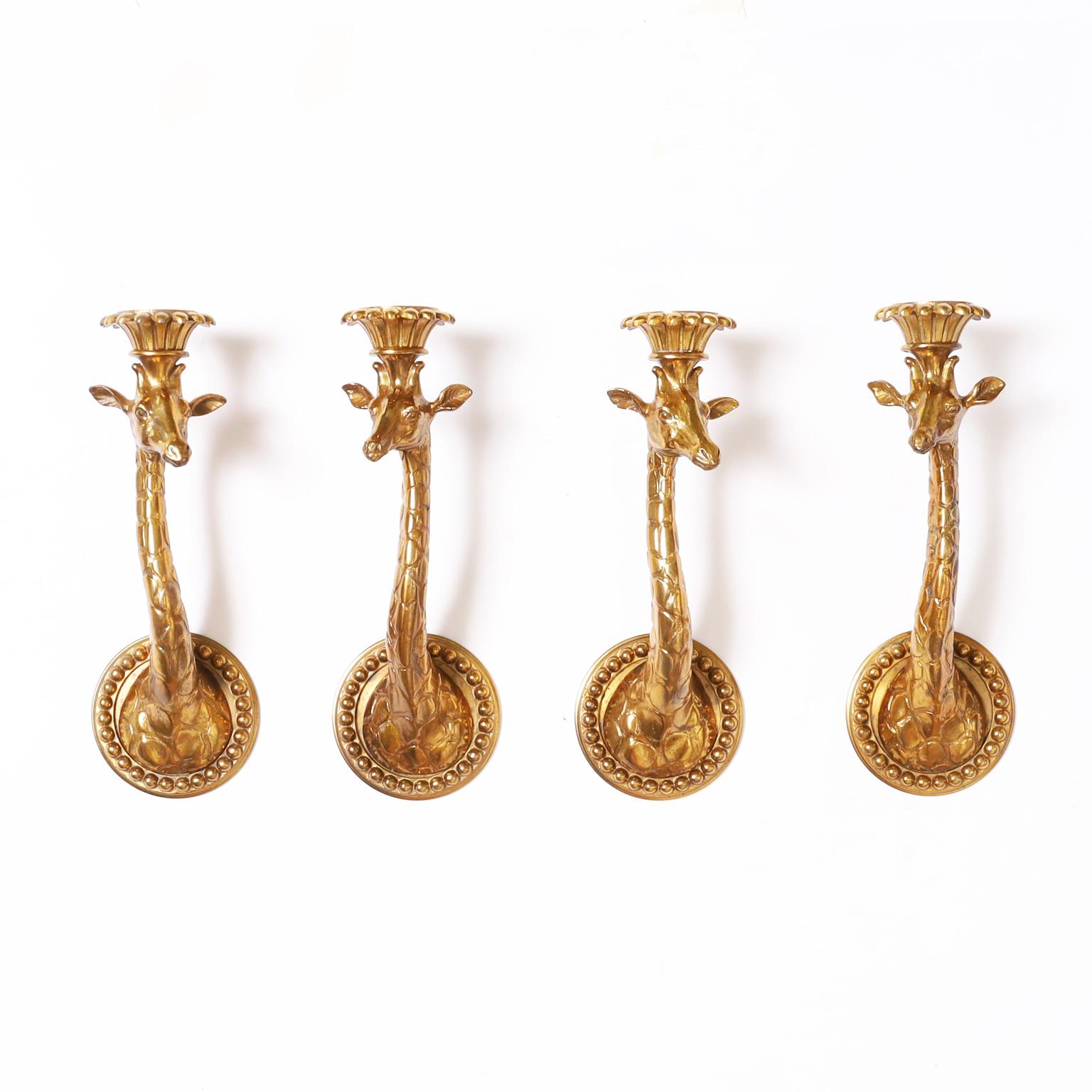 Standout set of four or two pairs of vintage Italian giraffe wall sconces crafted in bronze with a gilt finish having classical candle cups and wall backplates. Price of $3,950 is per pair.