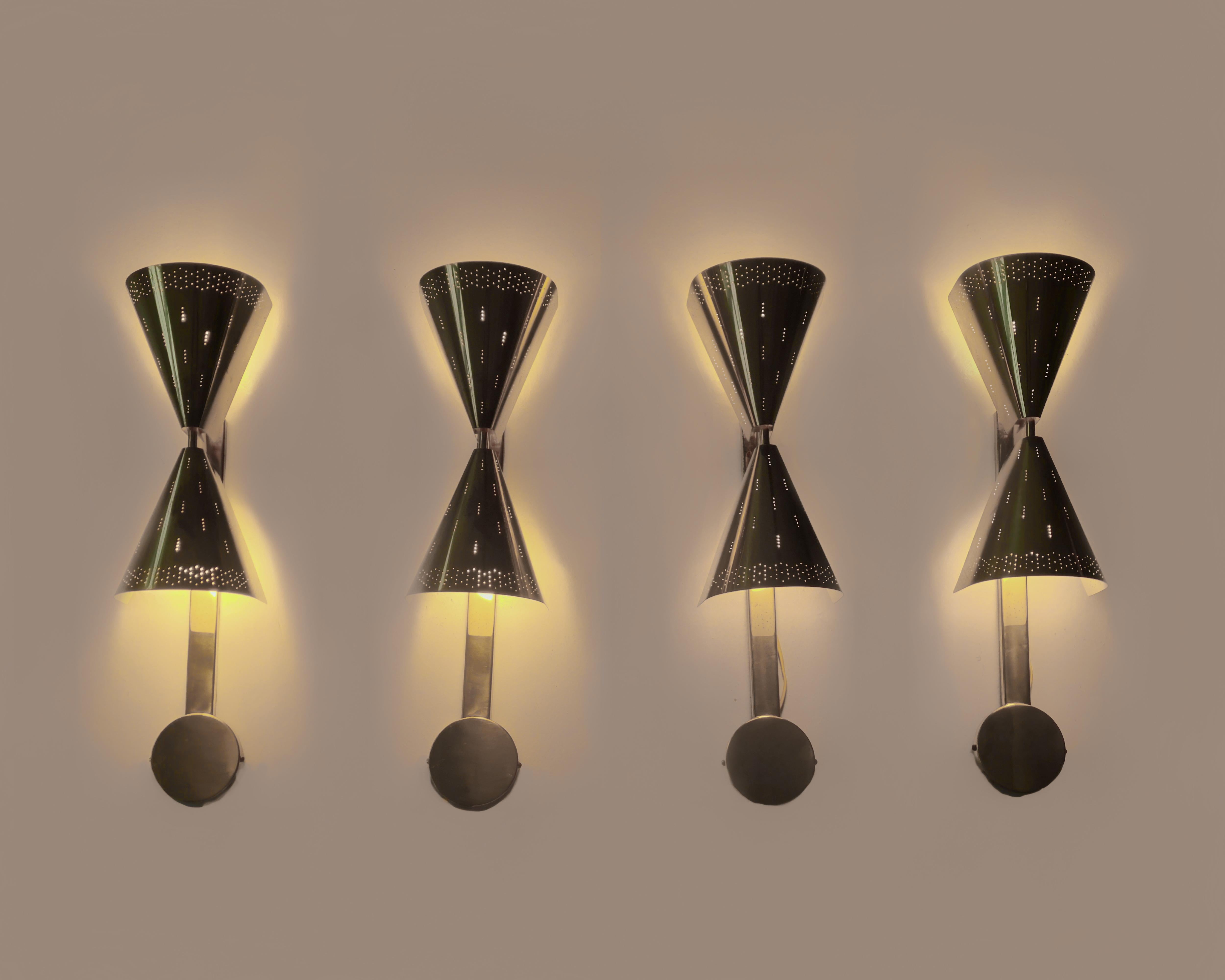 Rarely on offer, a commissioned set of four Paavo Tynell wall lamps from their original location in the Toijala region in Finland. This set of wall lights was designed specifically for the Akaa Congregation's main hall. The perforated brass