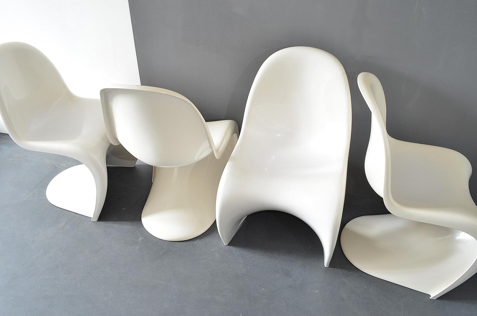 Set of four Panton chairs in white by Verner Panton for Fehlbaum / Hermann Miller, 1974. 
Version with reinforcement rips, Manufactures logo and date underneath.
