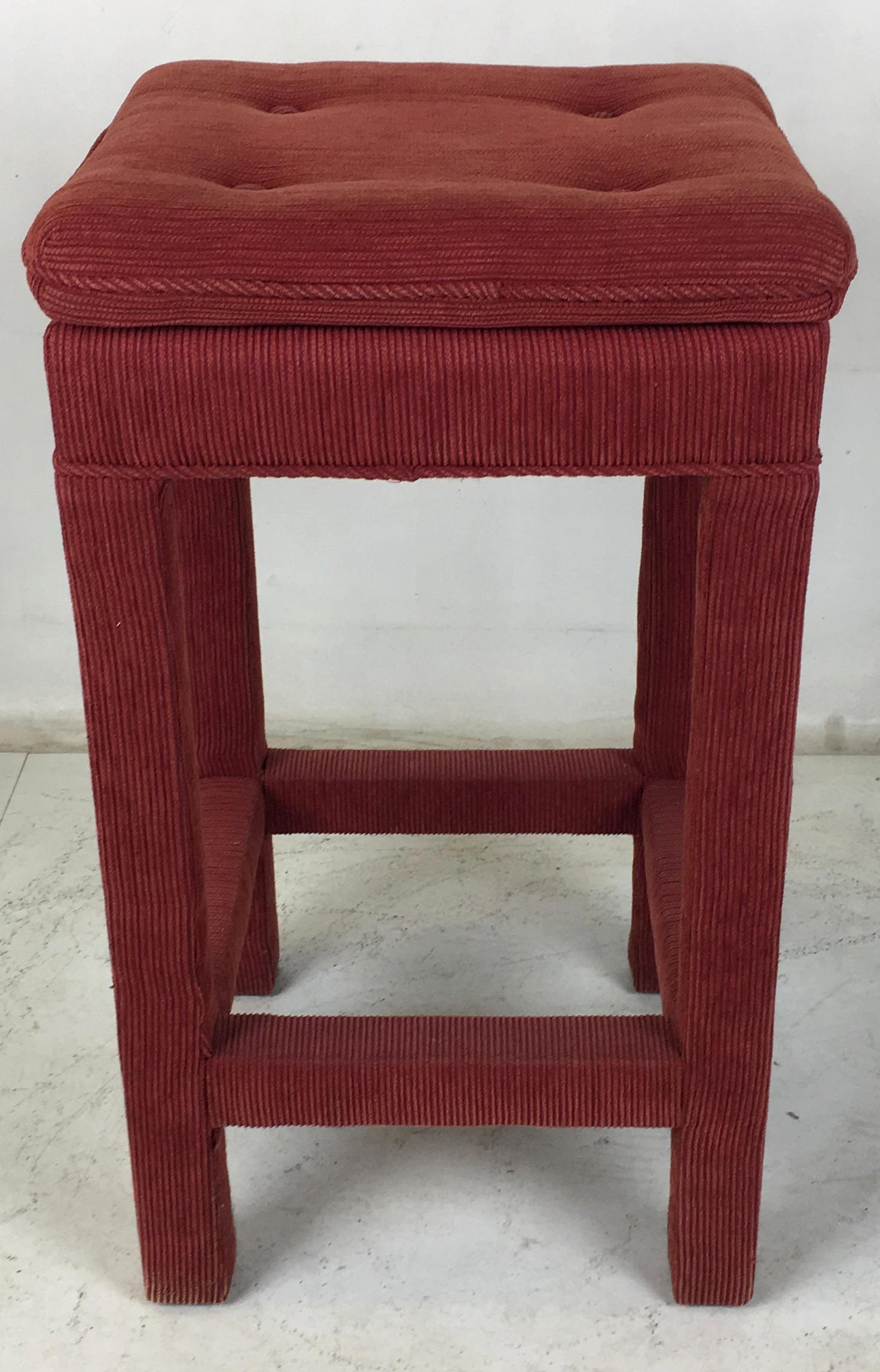 Four handsome classic Parsons style barstools in deep red ribbed cotton upholstery. The set have been reupholstered and can be used as-is if desired. The stretchers double as foot rests allowing the user to revolve to any side or corner. The seats